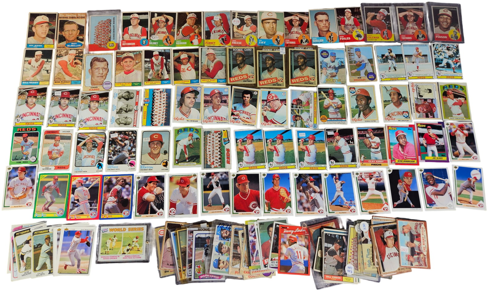 A Collection of Vintage and Modern Cincinnati Reds Baseball Trading Cards Featuring Star and Rookie: This extensive collection primarily focuses on the Cincinnati Reds franchise and includes cards from the late 1950s through the early 1990s. The lot features major manufacturers such as Topps, Donruss