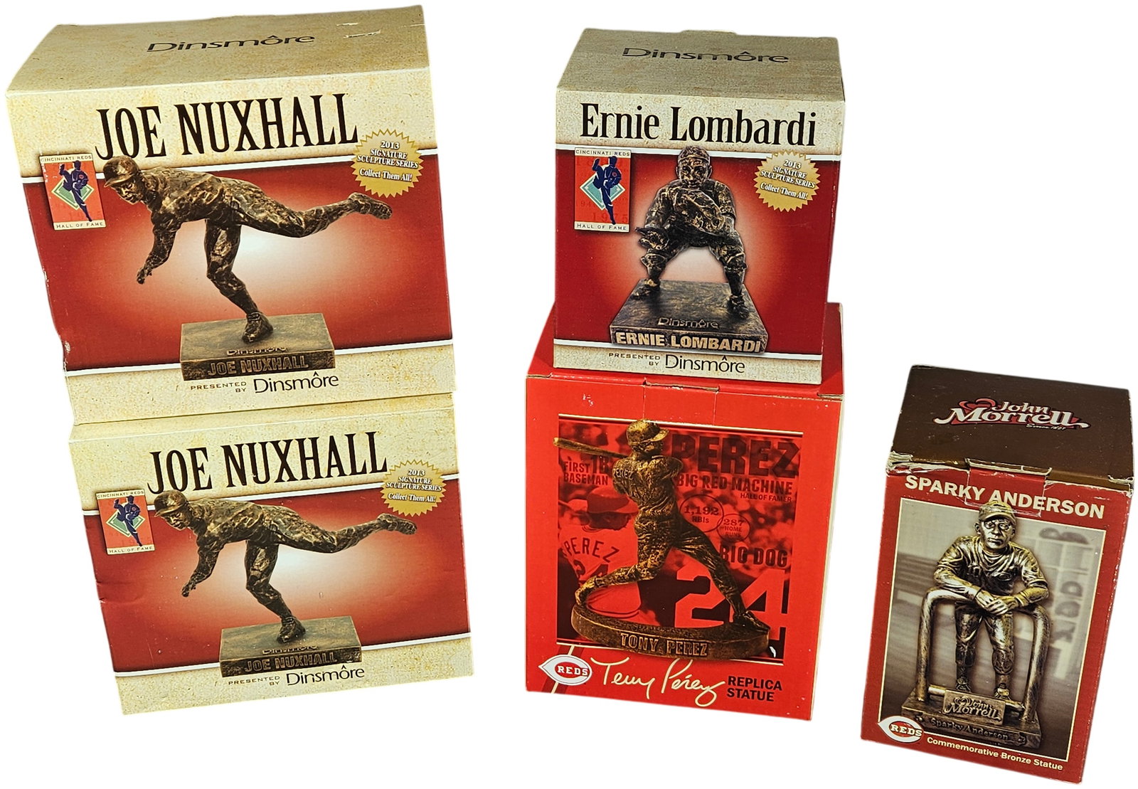 A group of Boxed Cincinnati Reds Commemorative Baseball Statues Including Nuxhall, Lombardi, Perez,: This collection consists of boxed commemorative statues honoring prominent figures from Cincinnati Reds history. The set includes pieces from the Dinsmôre 2013 Signature Sculpture Series, featuring t