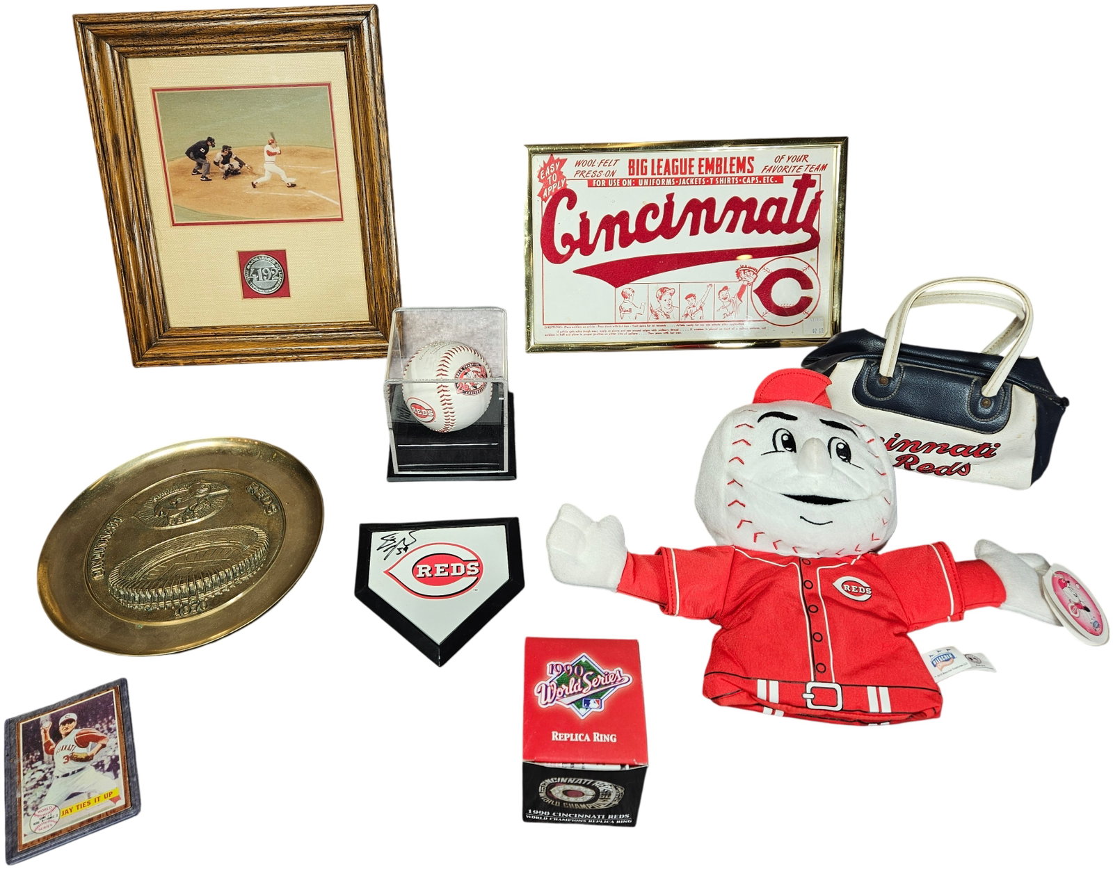 A Collection of Cincinnati Reds Memorabilia Featuring a 1990 World Series Replica Ring and: A collection of Cincinnati Reds baseball memorabilia spanning several decades of team history. The group includes a framed commemorative display featuring a photograph of Pete Rose and a medallion ins