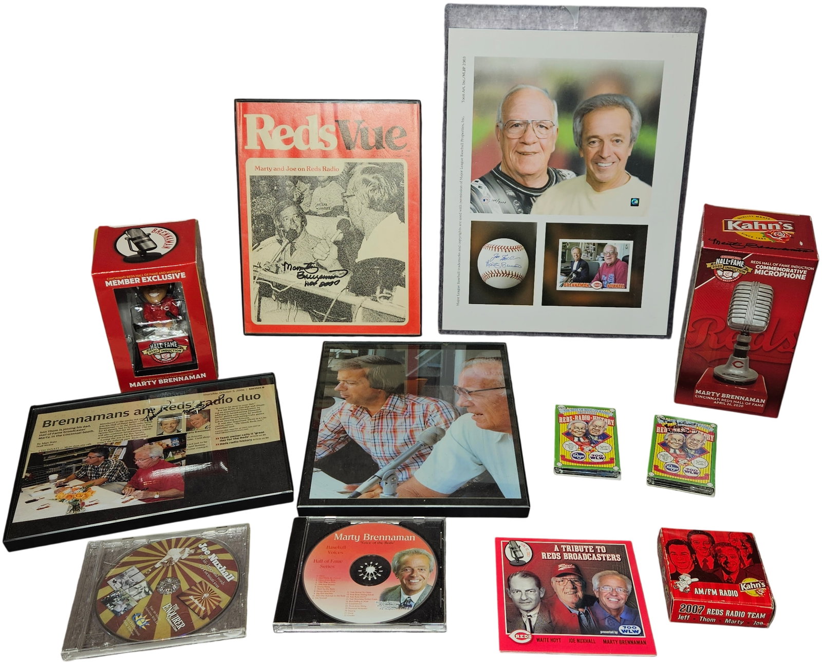A Collection of Cincinnati Reds Broadcasting Memorabilia featuring Marty Brennaman and Joe Nuxhall: This collection celebrates the careers of Hall of Fame announcers Marty Brennaman and Joe Nuxhall through various commemorative and media items. Notable pieces include a Marty Brennaman Reds Hall of F