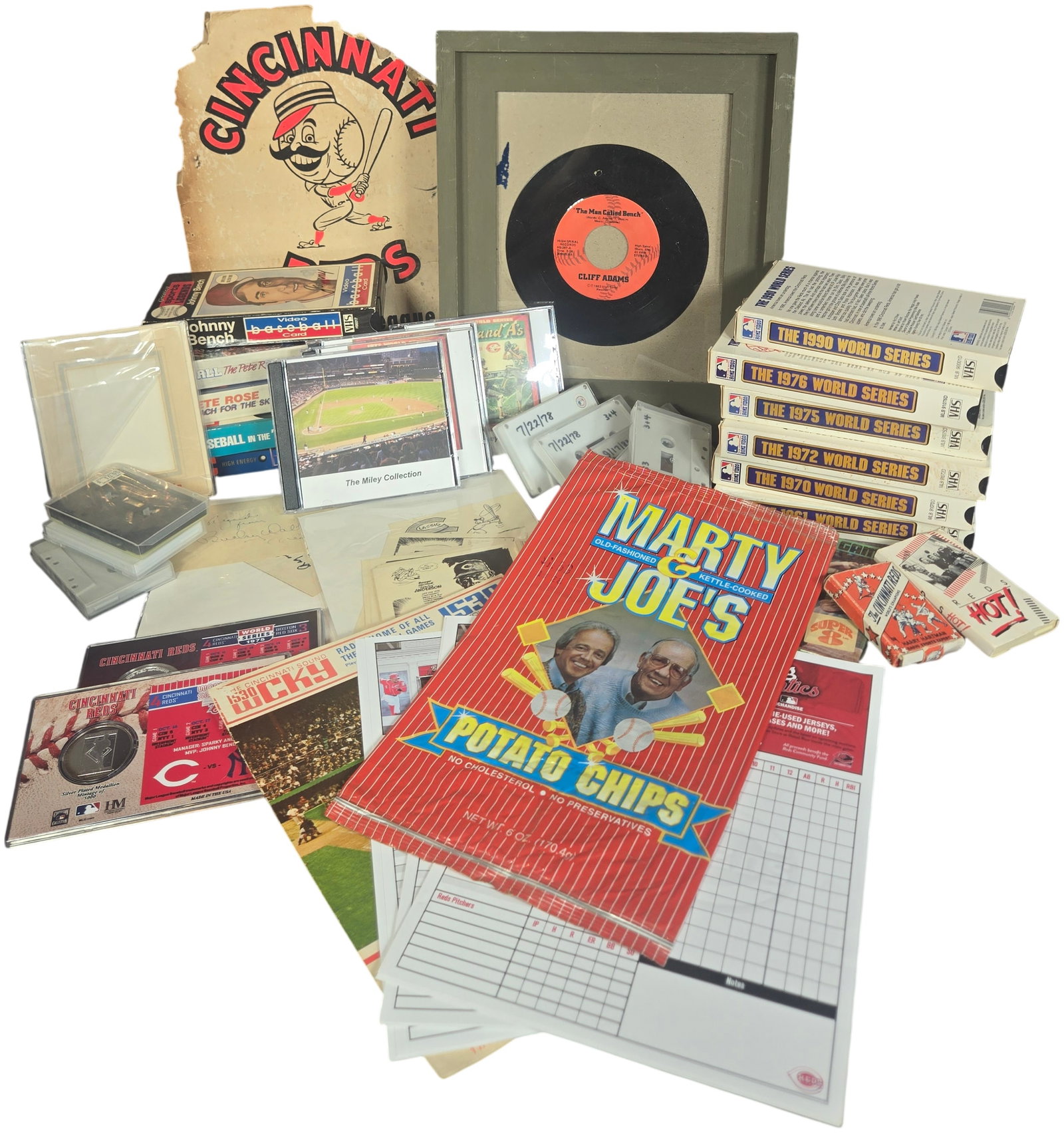A Collection of Cincinnati Reds Baseball Memorabilia Including World Series Highlights and Signed: An assortment of Cincinnati Reds baseball memorabilia constructed of paper, plastic, metal, and magnetic media, spanning from the 1920s through the early 1990s with a focus on the championship eras. T