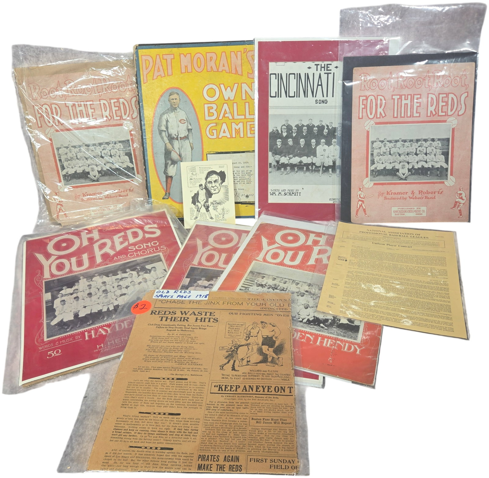 A Collection of Vintage Cincinnati Reds Baseball Sheet Music and Ephemera, Circa 1910-1919: This lot consists of a collection of early 20th-century Cincinnati Reds baseball memorabilia and ephemera, primarily focusing on the 1910s and the team's 1919 World Series championship period. The col