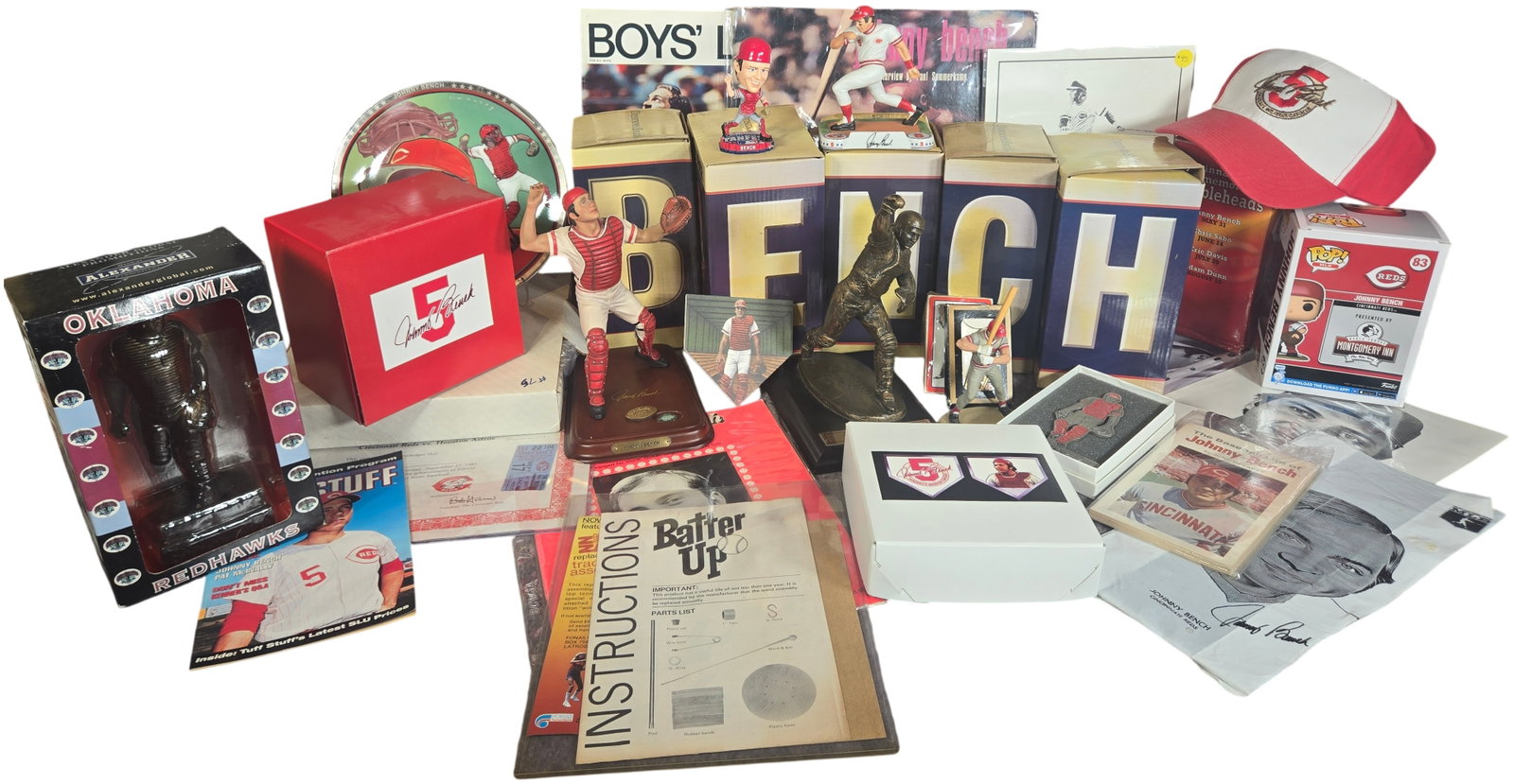 A Collection of Johnny Bench Cincinnati Reds Memorabilia Including Bobbleheads Figurines and: A collection of memorabilia featuring items by Dinsmore and Shohl, Danbury Mint, Funko, and Sports Impressions related to Cincinnati Reds catcher Johnny Bench. The assortment includes a boxed set of J