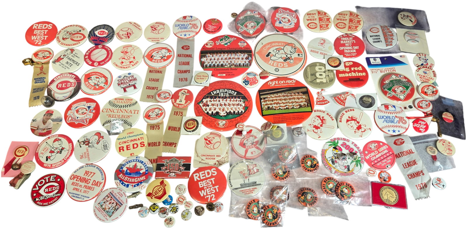 A Collection of Cincinnati Reds and Cincinnati Bengals Sports Memorabilia Featuring Pinback Buttons: This comprehensive assembly of sports and entertainment memorabilia focuses primarily on the Cincinnati Reds baseball organization. The collection includes various celluloid and metal pinback buttons,