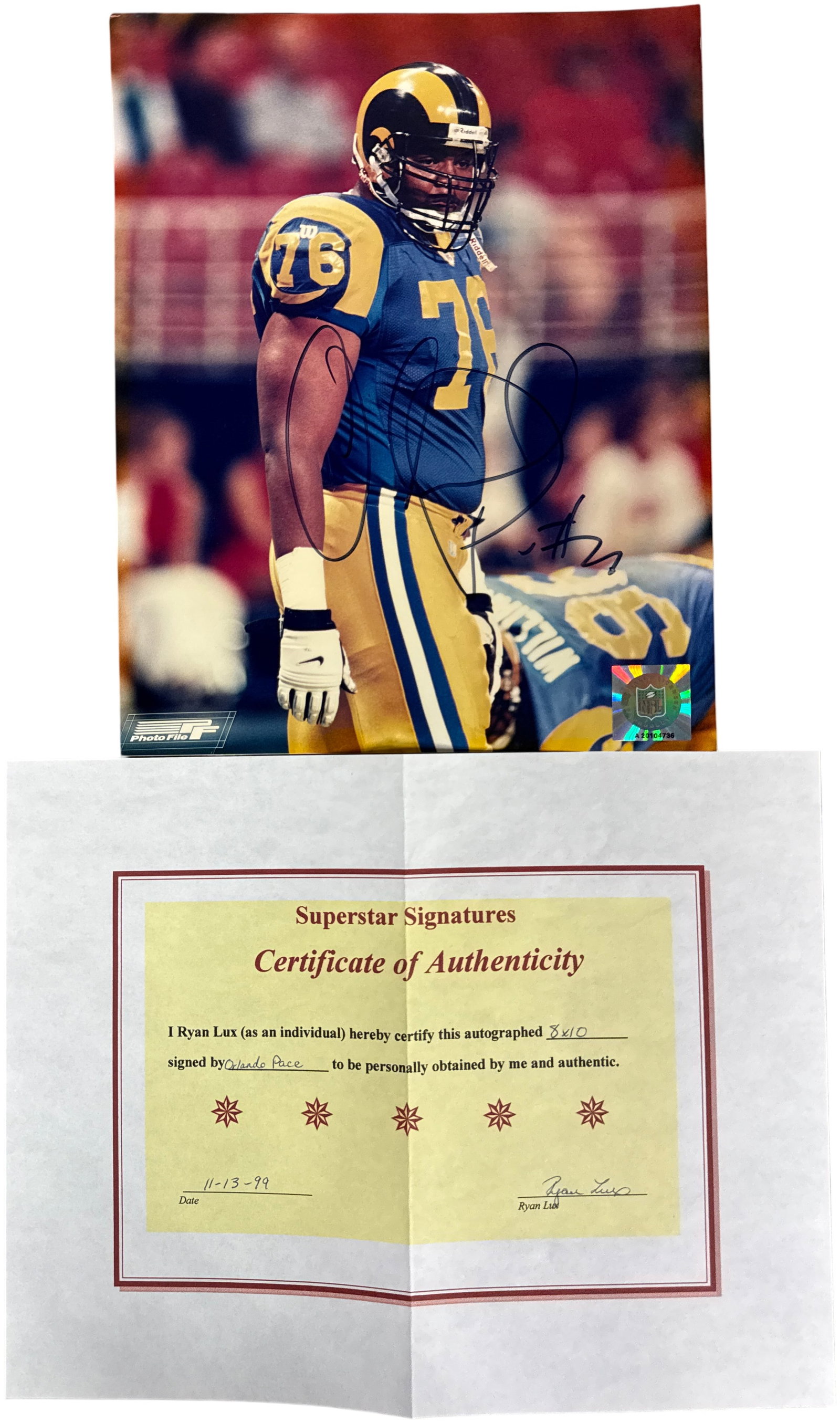 Orlando Pace Autographed St. Louis Rams Photo File 8x10 Photograph with Certificate of Authenticity: This is an autographed color photograph of Pro Football Hall of Fame offensive tackle Orlando Pace during his tenure with the St. Louis Rams. The image depicts Pace in a blue and yellow Rams uniform, 