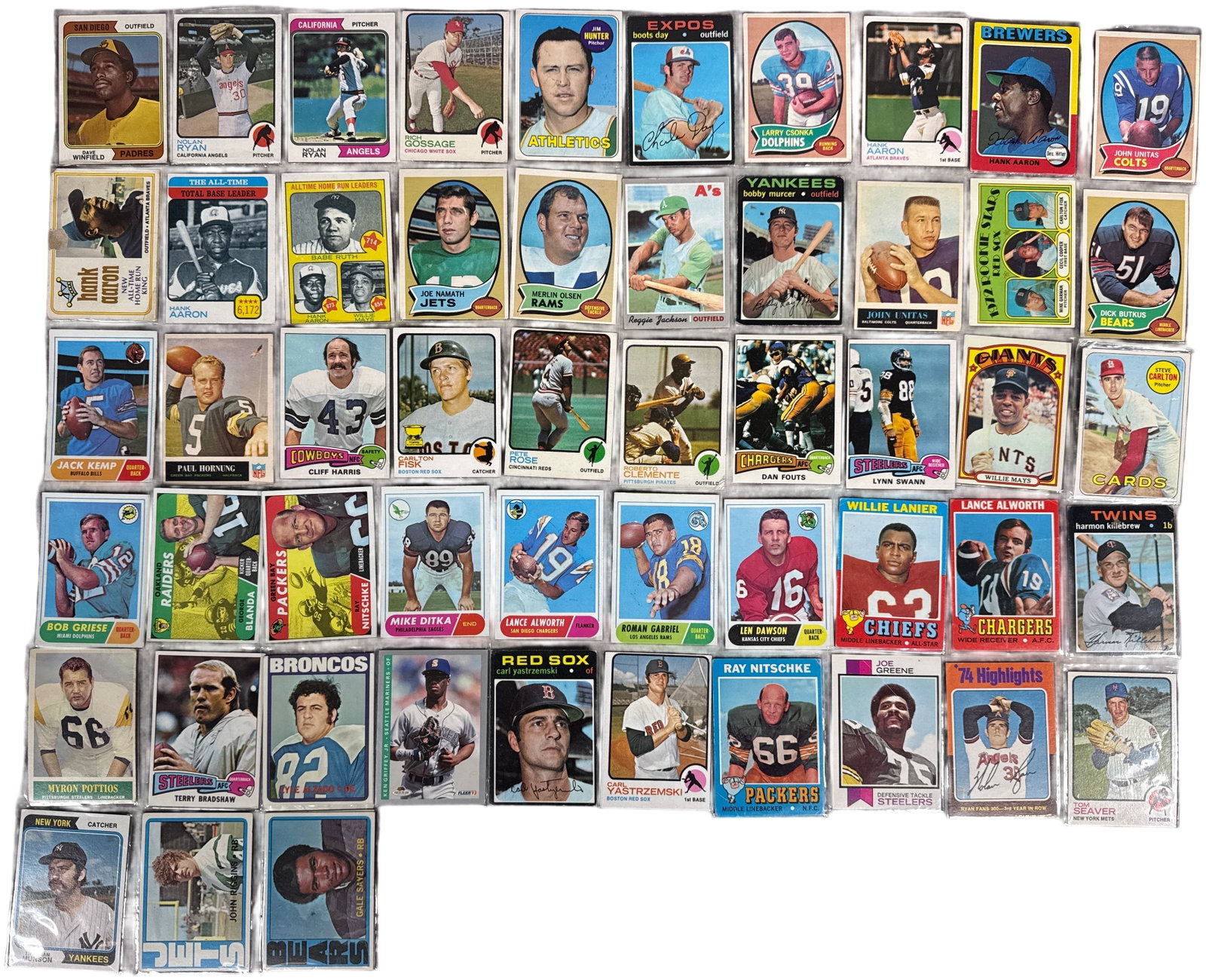 A Collection of Vintage Topps MLB and NFL Trading Cards Including Key Hall of Famers and Rookie: This collection consists of vintage sports trading cards primarily from the Topps brand, spanning the early-to-mid 1970s. The assembly includes significant Major League Baseball (MLB) and National Foo