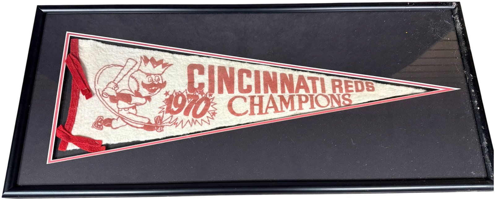 Framed 1970 Cincinnati Reds National League Champions Vintage Felt Pennant: This vintage felt pennant commemorates the 1970 Cincinnati Reds season, during which they secured the National League Championship. The item is constructed from off-white felt featuring red screen-pri