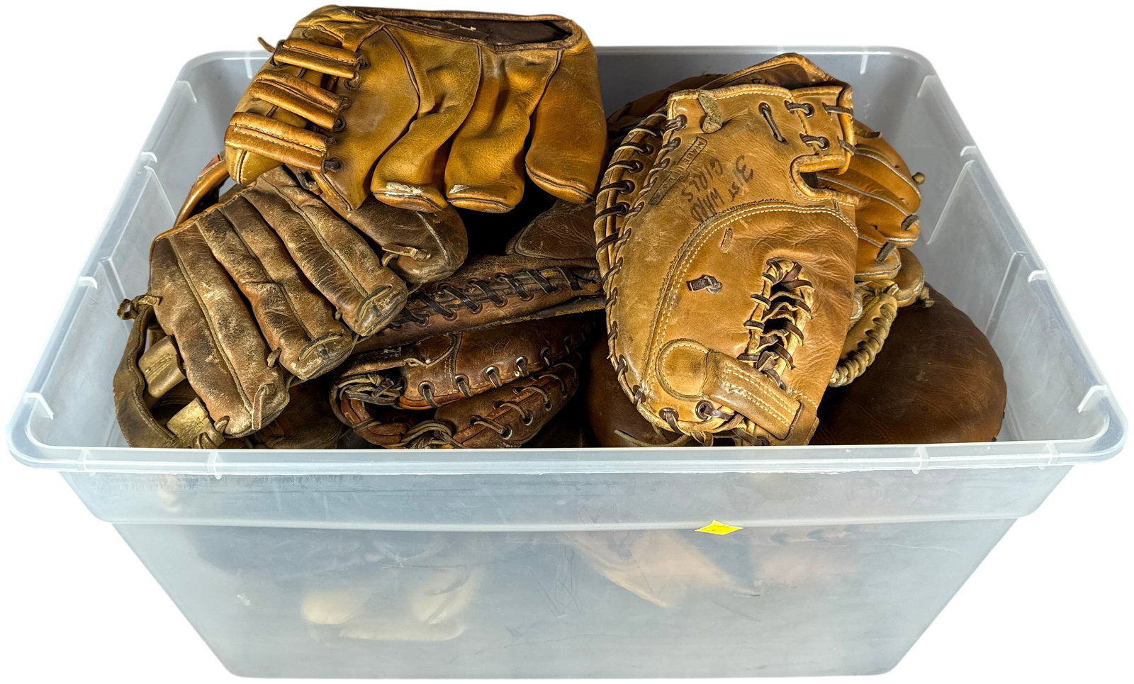 A Collection of Vintage Leather Baseball and Softball Gloves and Mitts: This collection features an assortment of vintage leather baseball and softball fielders gloves, catchers mitts, and first basemans mitts. Visible manufacturer markings and labels identify brands incl