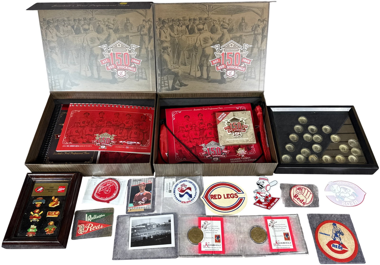 A Group of Cincinnati Reds Baseball Memorabilia including 150th Anniversary Commemoratives and 1990: This group of Cincinnati Reds sports memorabilia spans several decades of the franchise history. Central to the lot are commemorative boxes marking the 150th anniversary of the Cincinnati Red Stocking