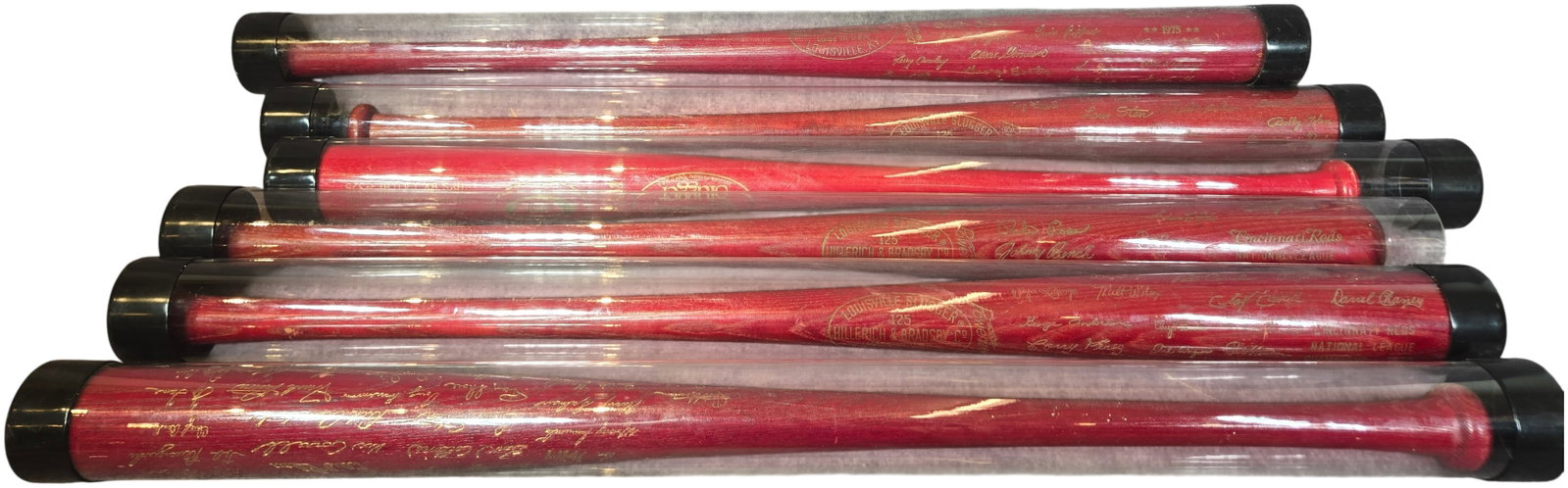 A Collection of Cincinnati Reds Commemorative Louisville Slugger Baseball Bats: An assortment of commemorative baseball bats produced by Louisville Slugger (Hillerich and Bradsby Co.) honoring various milestones of the Cincinnati Reds franchise. Each bat is constructed of wood wi