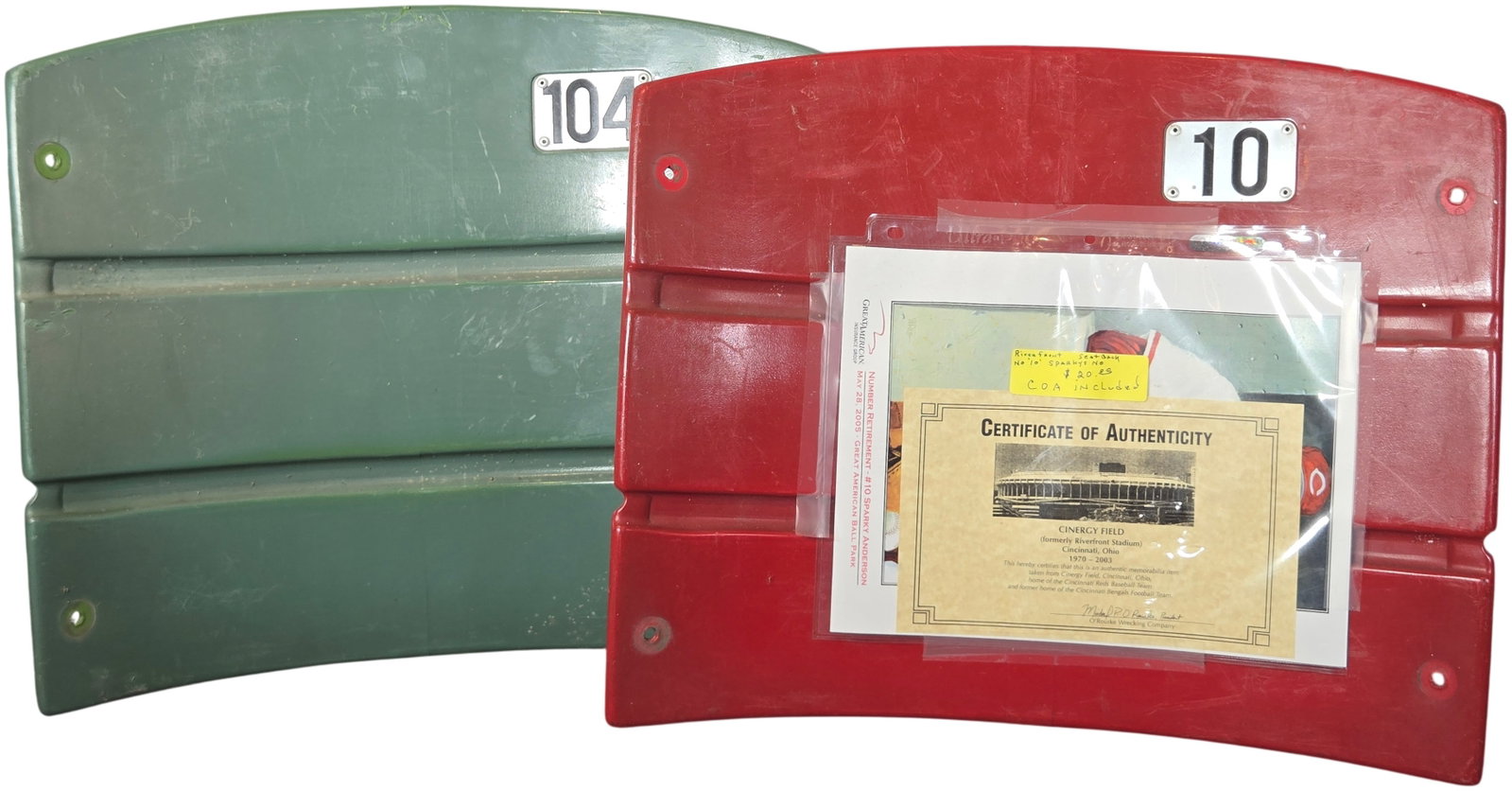 A Pair of Cincinnati Riverfront Stadium Seat Backs Numbers 10 and 104: This lot features molded plastic stadium seat backs from Riverfront Stadium, later known as Cinergy Field, in Cincinnati, Ohio. The stadium was the former home of the Cincinnati Reds baseball team and