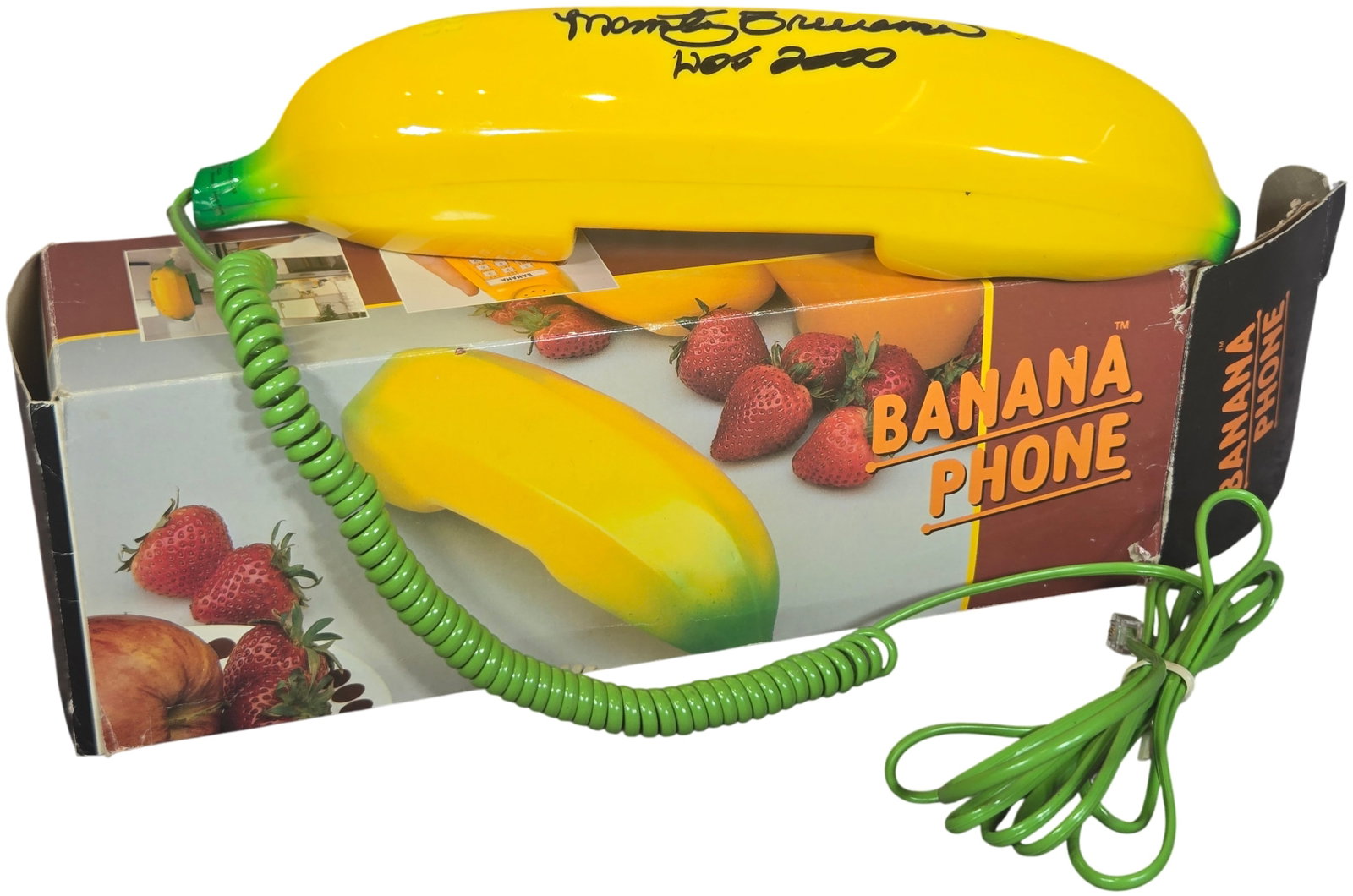 Vintage Novelty Banana Phone Model BP-302 Inscribed by Monty Brinson: This is a novelty corded landline telephone designed in the form of a banana, model BP-302, marketed under the trade name Banana Phone. The unit is constructed of molded yellow plastic with green