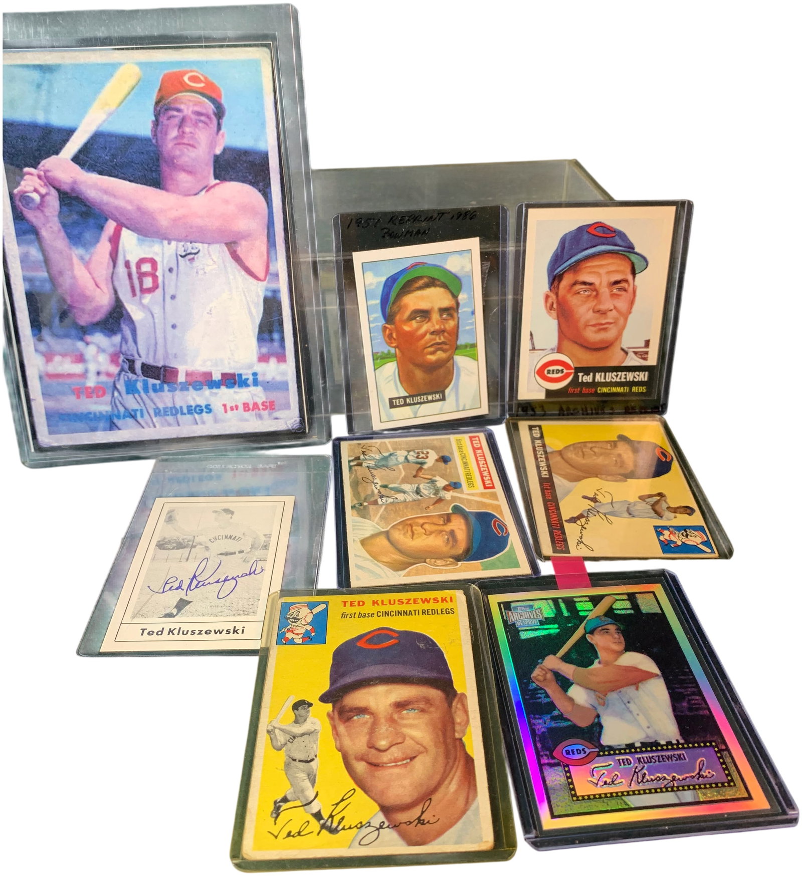 A Lot of (8) Ted Kluszewski Cincinnati Reds Baseball Cards and Signed Item Including 1953-1957 Topps: This lot features a collection of items highlighting Cincinnati Reds star Ted Kluszewski. The primary focus of the collection is a substantial run of vintage Topps cards from the 1950s. The assortment