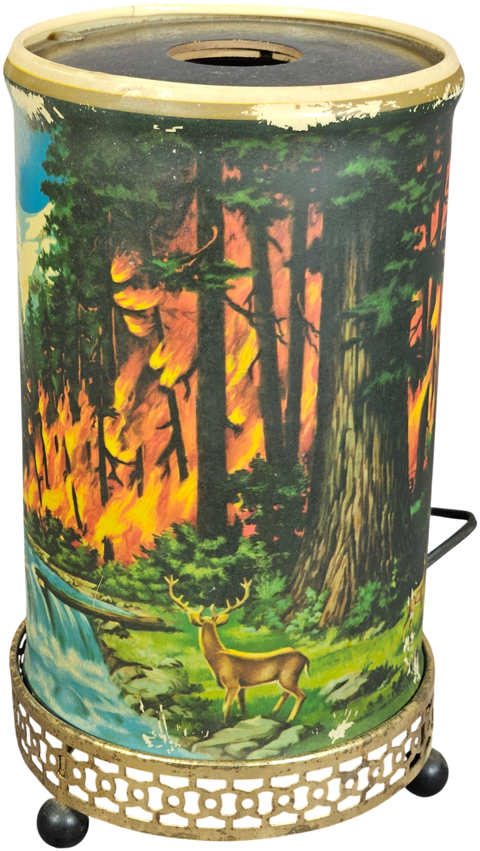 Econolite Model 761 Forest Fire Motion Lamp: An Econolite Corporation motion lamp, model 761, featuring concentric cylindrical plastic shades mounted on a circular, pierced brass-toned metal base with four ball feet. The outer shade displays a c