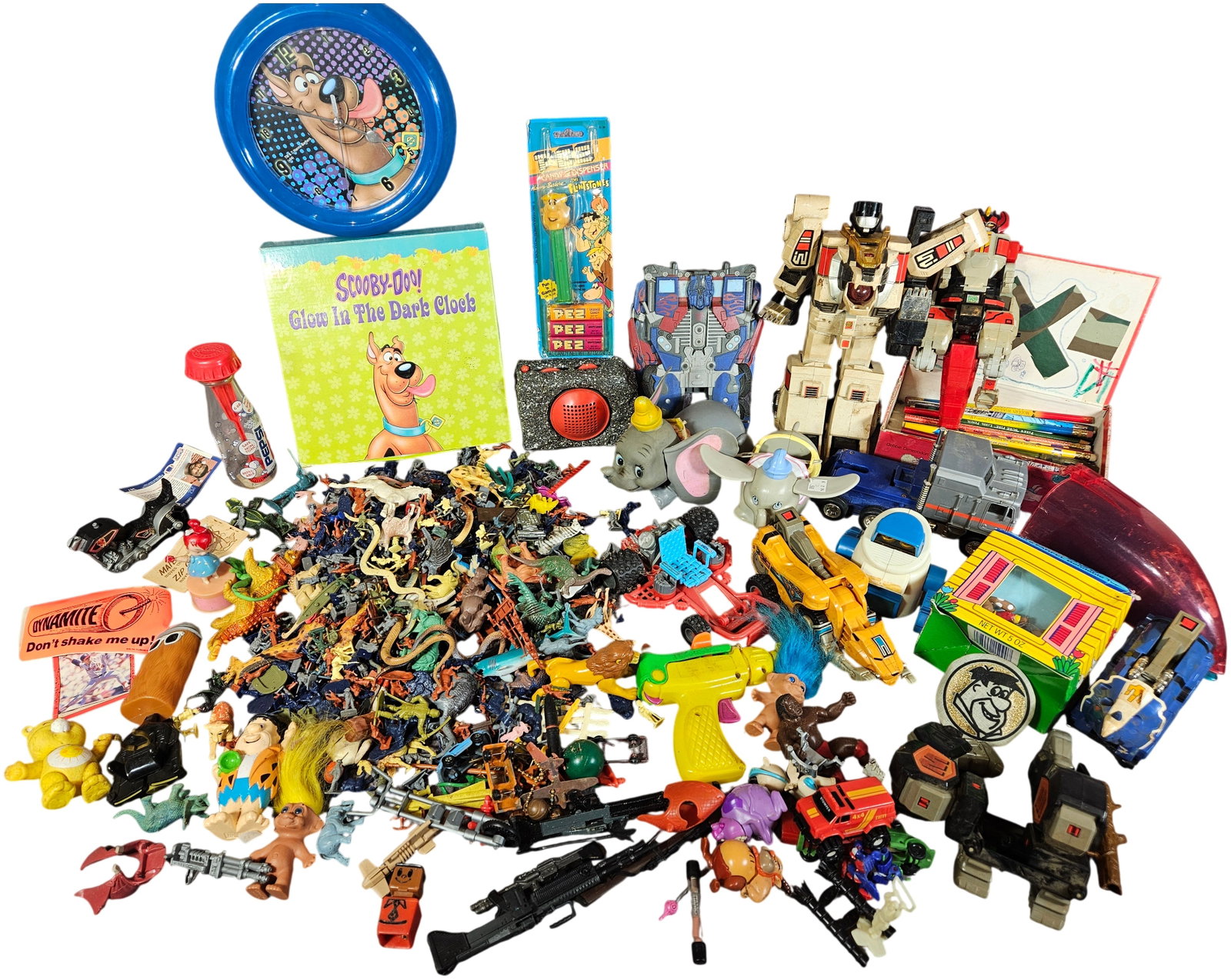 A Collection of Vintage Toys and Collectibles including G1 Transformers, Scooby-Doo, and The: This lot comprises a large assortment of vintage and modern toys and collectibles spanning various licensed properties and categories. Featured items include a vintage Hasbro G1 Transformers Jetfire r