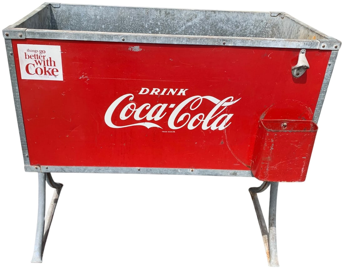 Vintage Coca-Cola Model 163 Metal Ice Chest on Stand: A vintage Coca-Cola beverage cooler, designated as Model 163. The unit features a rectangular metal body with a red painted finish and an embossed white Coca-Cola logo in Spencerian script on the fron