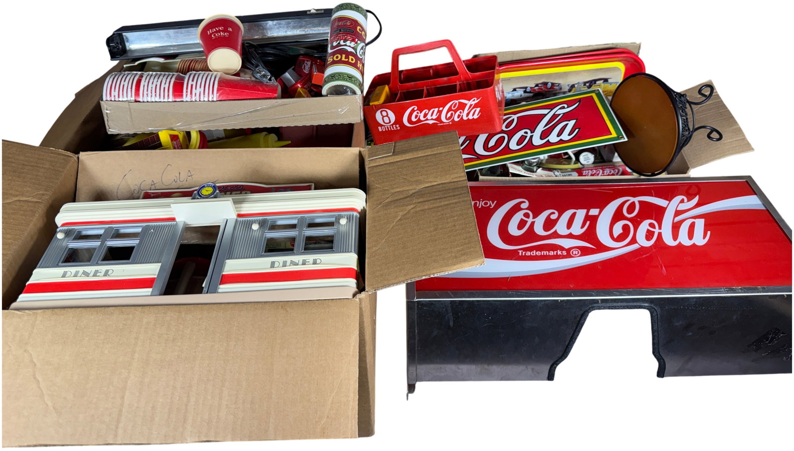 A Large Collection of Coca-Cola Branded Advertising Memorabilia and Collectibles: This comprehensive lot of Coca-Cola branded merchandise features a mid-century diner theme, consisting primarily of commemorative and reproduction pieces manufactured in the late 20th century. The col