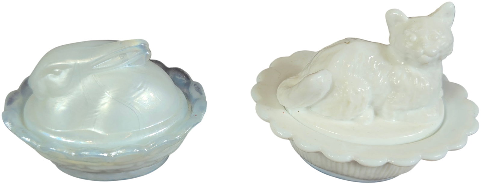 A Pair of Miniature Glass Animal-on-Nest Covered Dishes, Boyd and Attributed to Westmoreland: This lot features a pair of miniature animal-on-nest covered glass dishes produced in the United States. The first piece is a rabbit on nest by Boyd's Crystal Art Glass of Cambridge, Ohio. It is craft