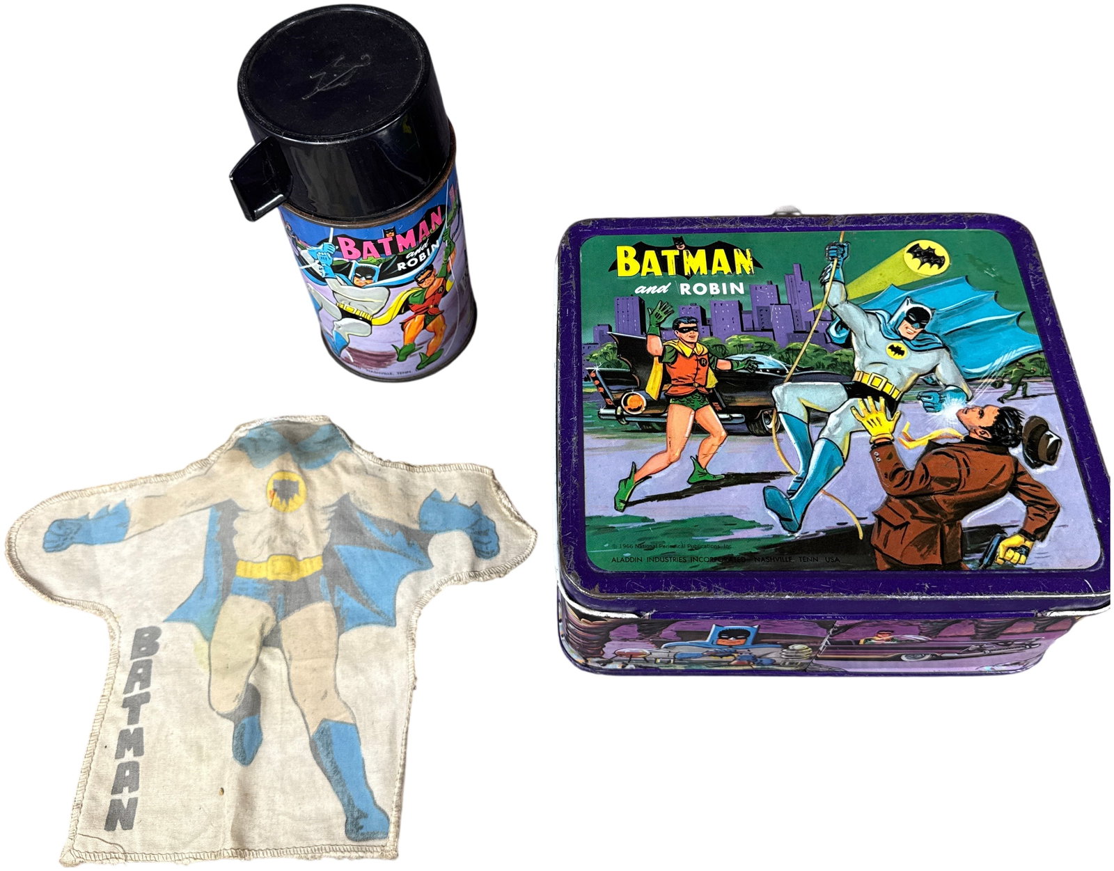 A 1966 Aladdin Industries Batman and Robin Lunchbox Set with Thermos and Hand Puppet: This is an Aladdin Industries Batman and Robin character lunchbox set featuring lithographed tin graphics based on the DC Comics characters. The set includes a lunchbox, a matching thermos, and a scre