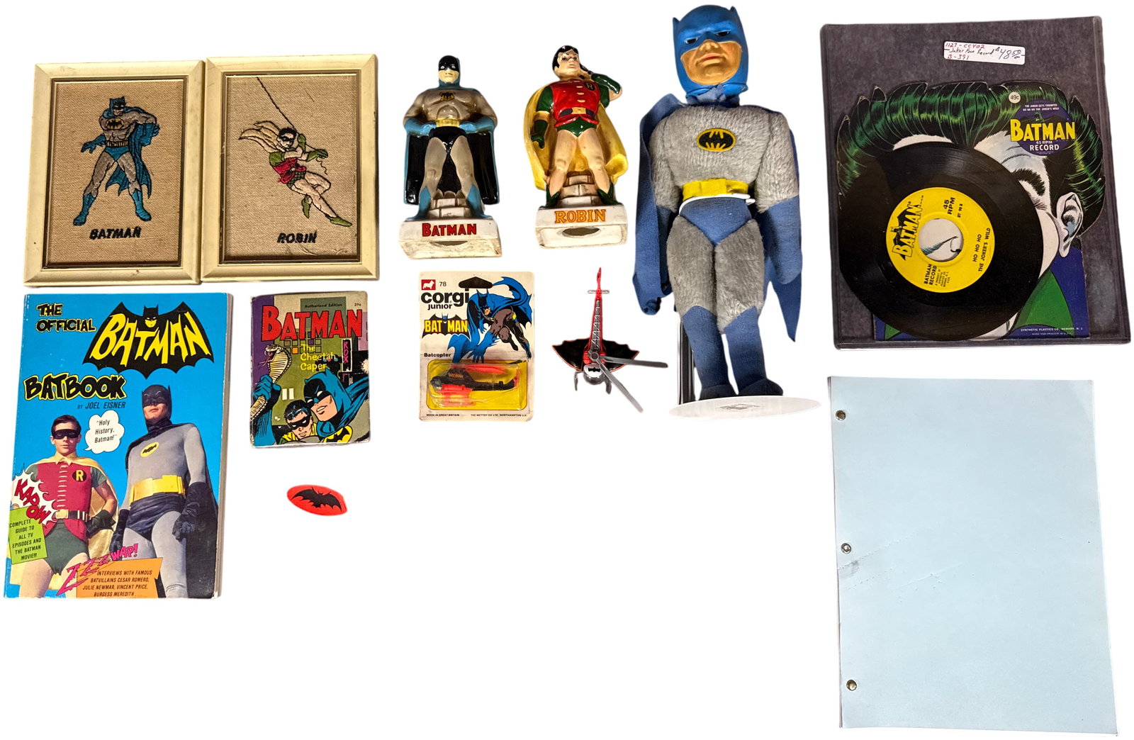 A Collection of Vintage Batman Memorabilia Including Toys, Ceramics, and Media: An assortment of vintage Batman memorabilia primarily dating from the mid-1960s to the 1980s. The collection includes a pair of hand-painted ceramic pedestal figures or banks, each featuring a molded 