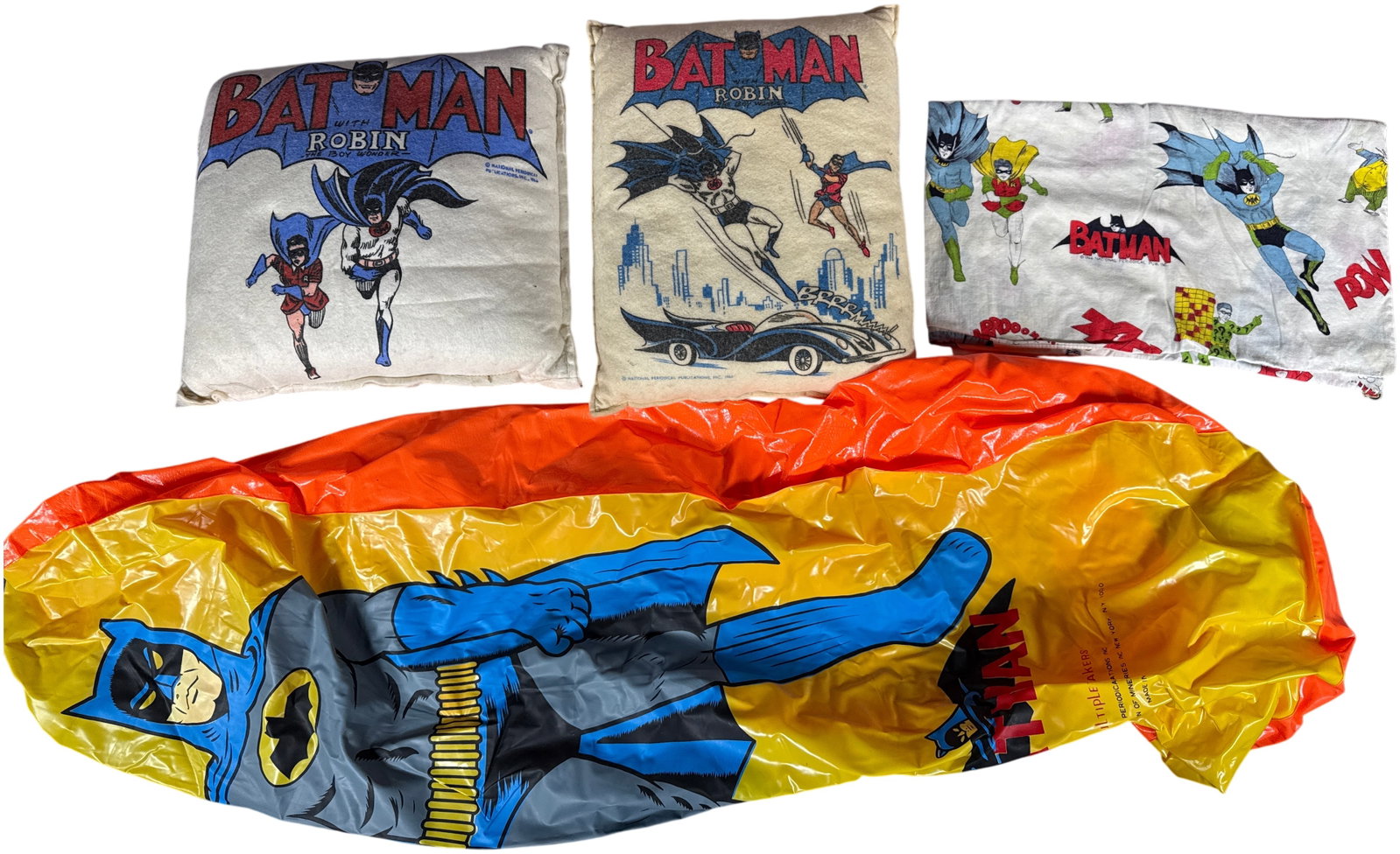 A Collection of Vintage Batman Licensed Memorabilia 1966: An assortment of officially licensed Batman-themed merchandise dating to 1966, coinciding with the era of the live-action television series. This collection includes a vinyl inflatable bop bag, plush 