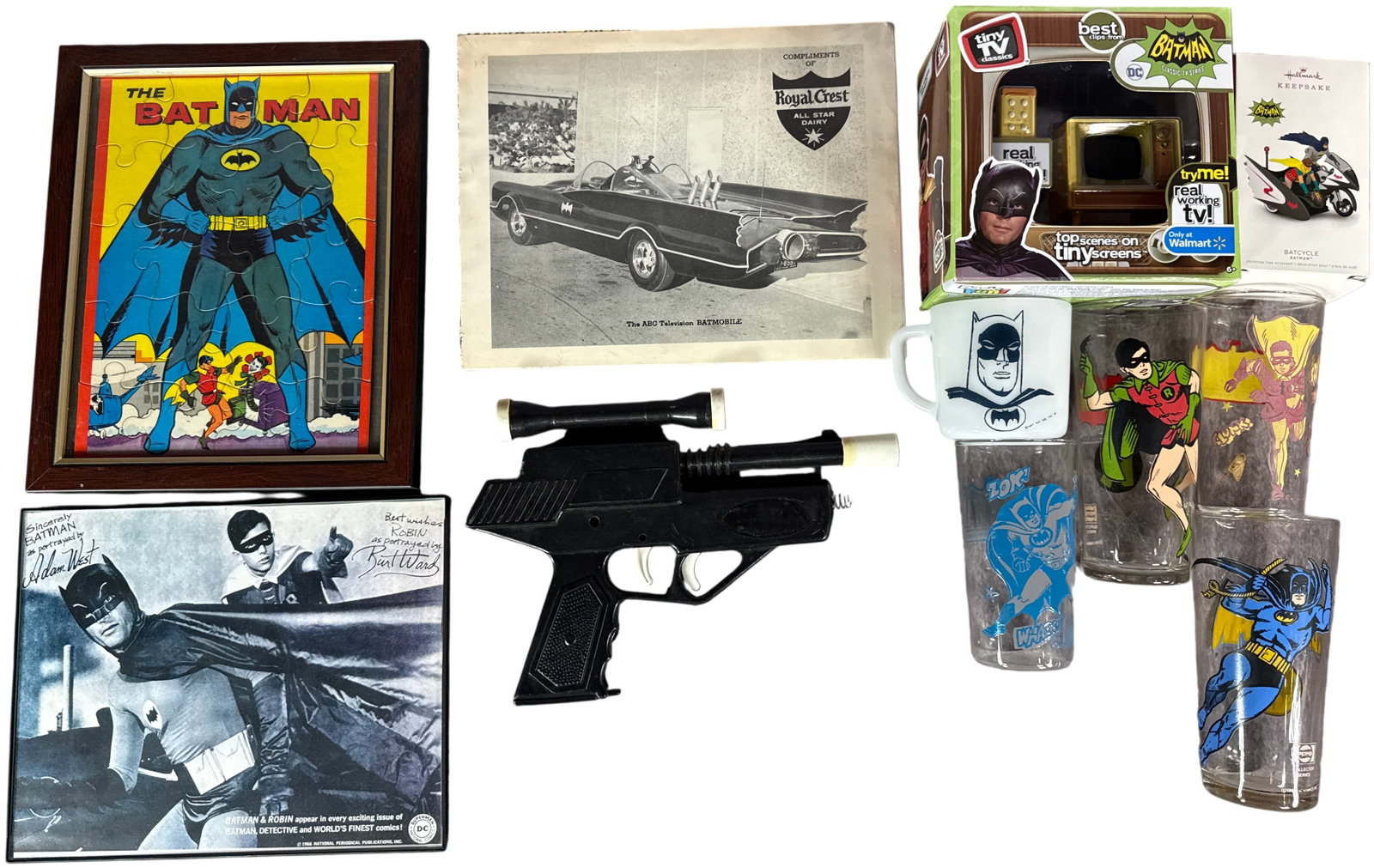 A Collection of Batman Memorabilia and Collectibles Including Drinking Glasses, Toys, and Framed: This collection of Batman-themed memorabilia includes items dating from the 1960s through the 2000s. The drinkware consists of clear drinking glasses and a white milk glass mug. of the glasses are fro