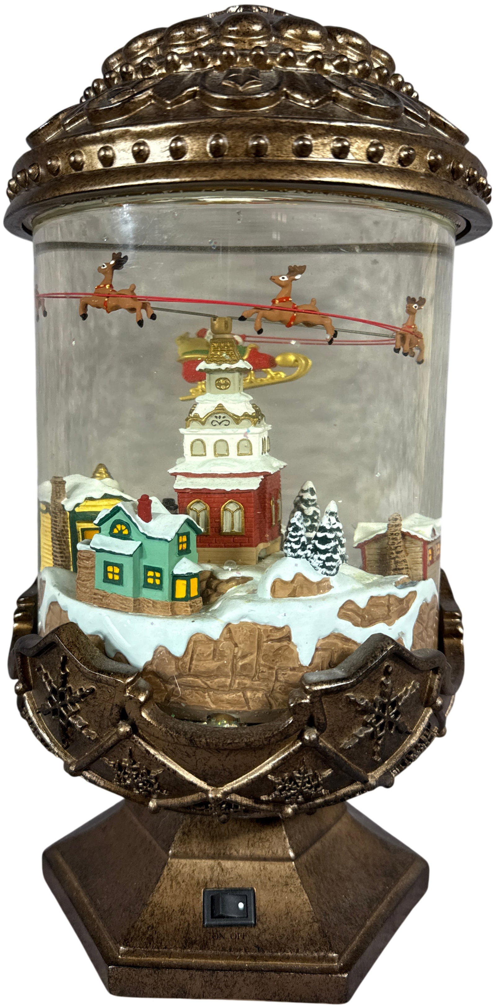 Hallmark Santa Claus in Sleigh and Winter Village Animated Snow Globe: This is a contemporary battery-operated Christmas snow globe manufactured for Hallmark Cards, Inc. The item features a large, cylindrical glass globe containing water and iridescent glitter. Centered 