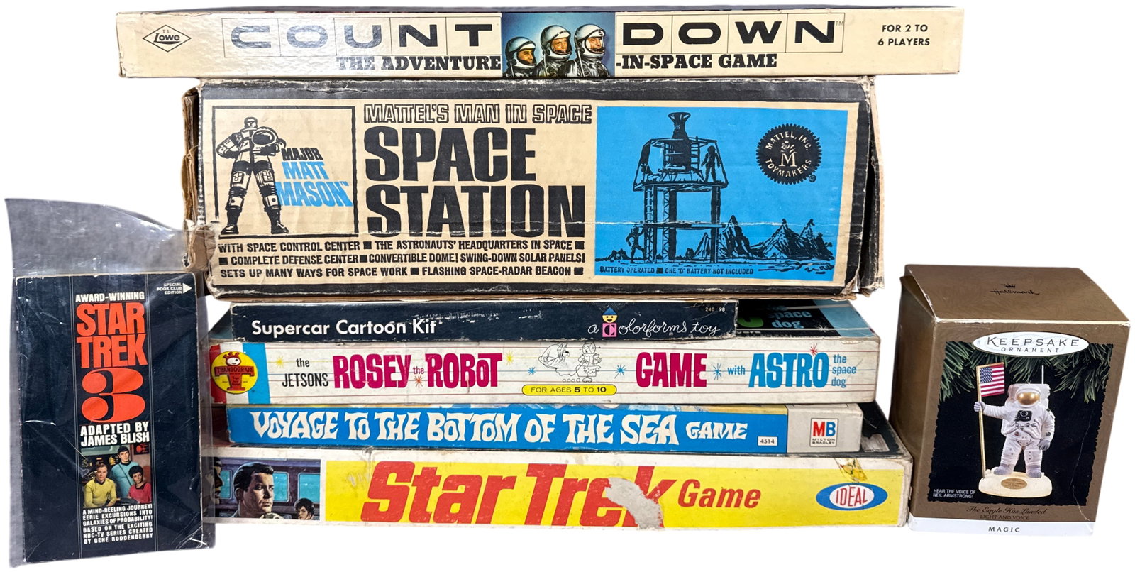 A Collection of Vintage Space and Science Fiction Games, Playsets, and Memorabilia: This group of mid-century collectibles features several iconic space-age and media franchises from the 1960s through the 1990s. Included are a Mattel Major Matt Mason Space Station playset in its orig