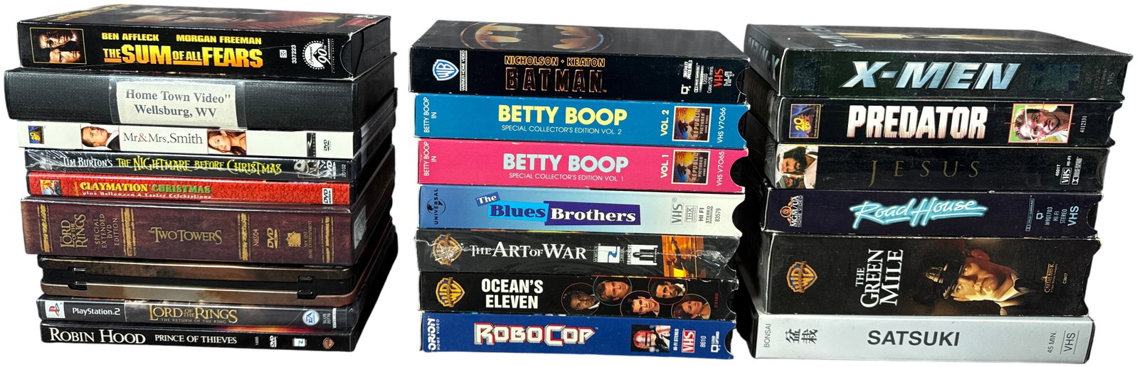 A Collection of Vintage Home Media Items Including VHS Tapes, DVDs, and a PlayStation 2 Game (1 of 4)