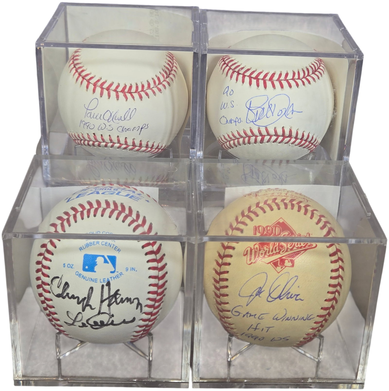A group of Cincinnati Reds Autographed Baseballs Including 1990 World Series Items: A collection of autographed baseballs primarily featuring members of the Cincinnati Reds. The collection includes a Joe Oliver autographed baseball featuring a printed 1990 World Series logo, signed i