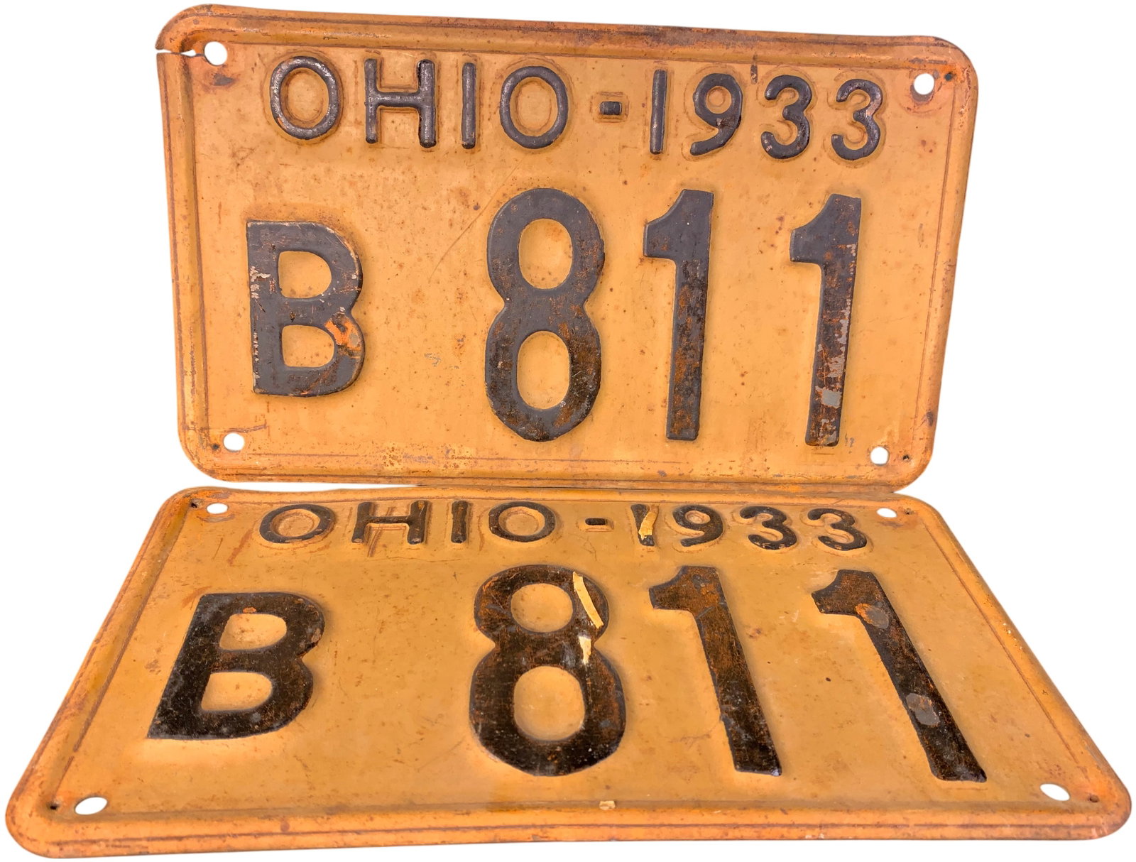 A Pair of 1933 Ohio Passenger Vehicle License Plates, Number B 811: This lot consists of a matched pair of official 1933 Ohio state vehicle registration plates. The plates are made of embossed metal, featuring a yellow-orange background with dark embossed characters. 