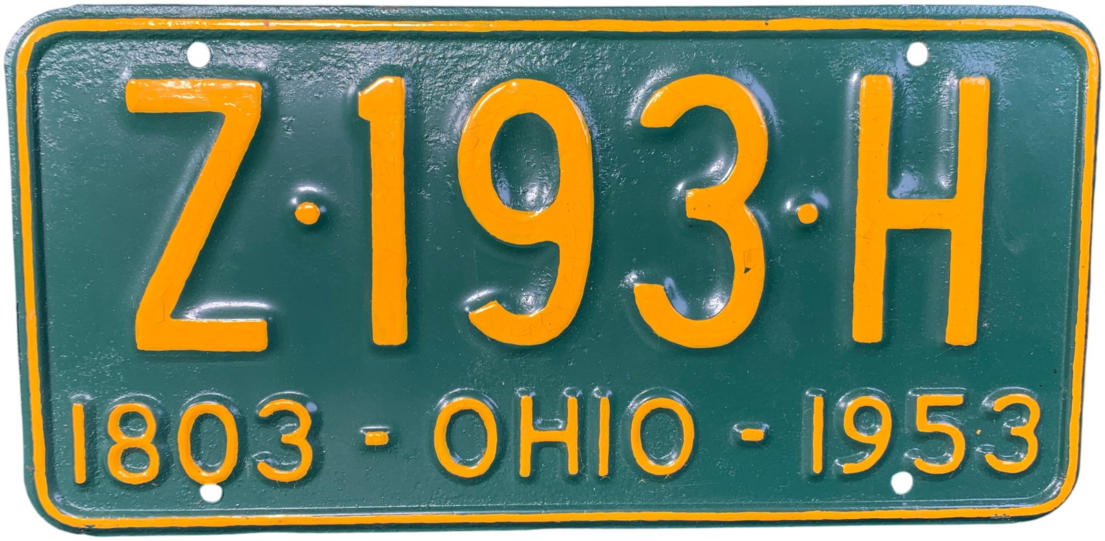 1953 Ohio Sesquicentennial License Plate Z 193 H: This vintage 1953 Ohio license plate was issued to commemorate the state's sesquicentennial year. The plate is constructed from embossed steel and features a dark forest green background with yellow-o