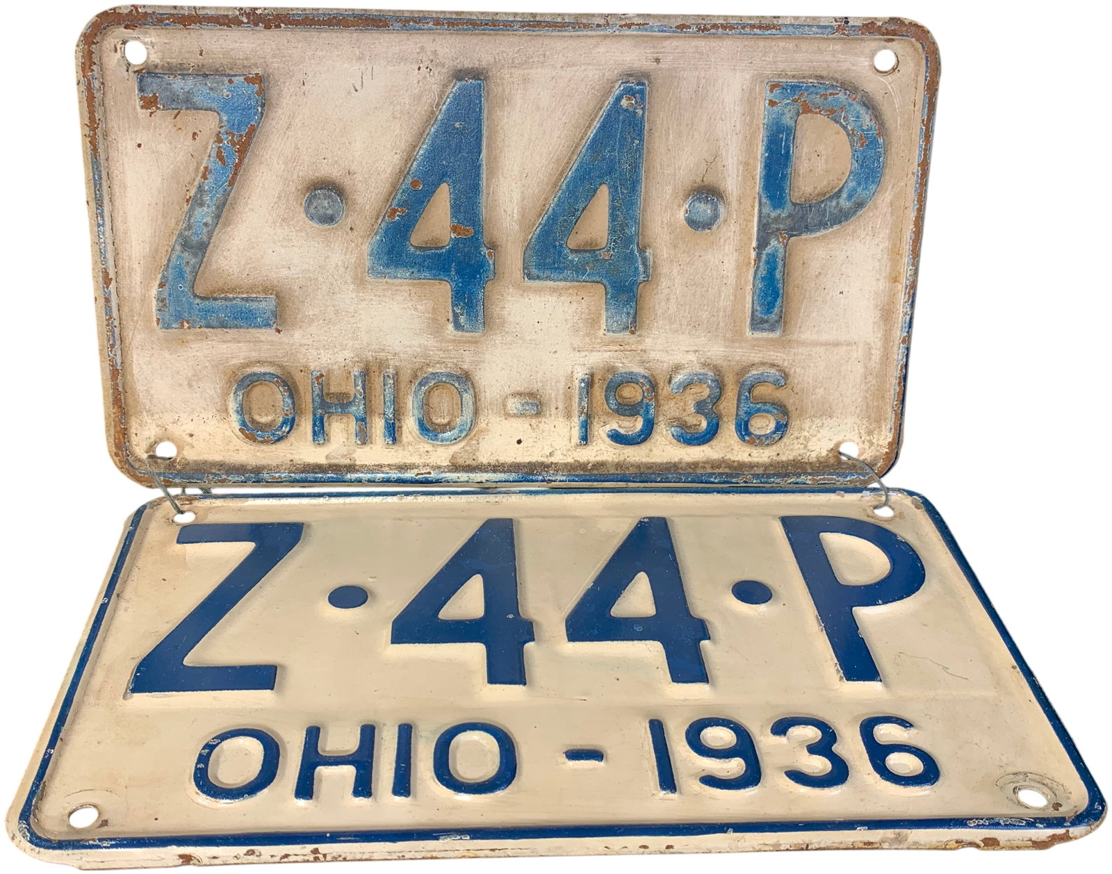 A Pair of 1936 Ohio License Plates: A matched pair of embossed metal license plates issued by the State of Ohio for the year 1936. The plates feature dark blue alphanumeric characters Z-44-P on a cream-colored background. The lower marg