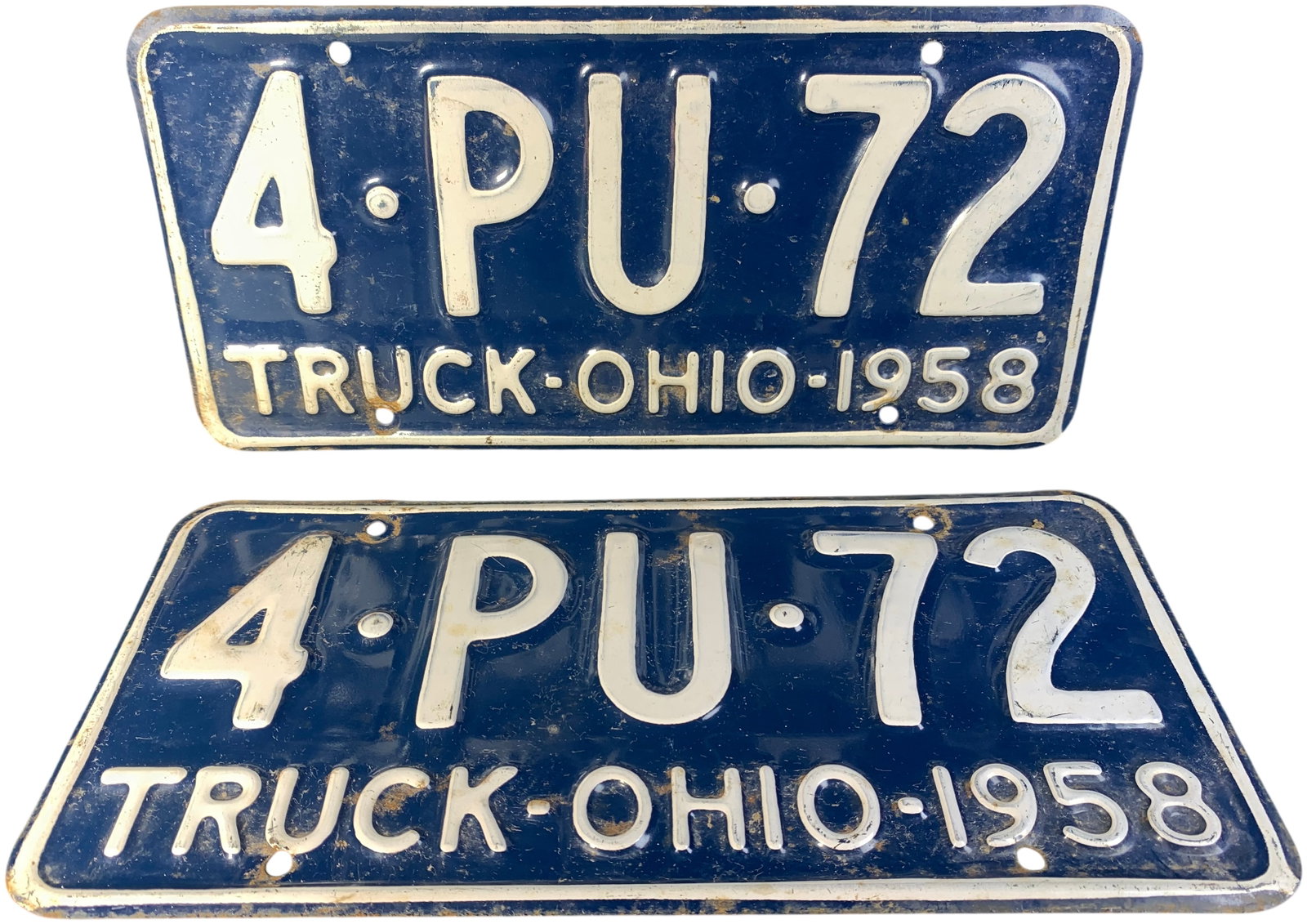 A Pair of Vintage 1958 Ohio Truck License Plates: A pair of original embossed metal license plates issued by the state of Ohio for truck registration in 1958. The plates feature a dark blue background with white embossed characters and a white perime