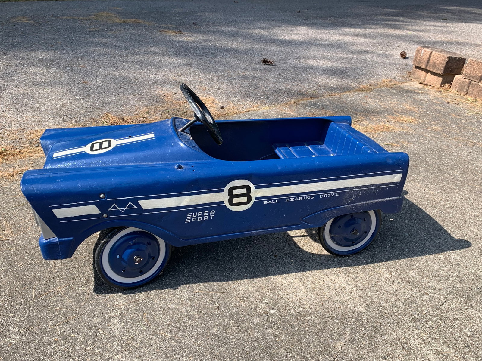 Murray Super Sport Eight Pedal Car: A vintage pedal car manufactured by Murray Ohio Manufacturing Co., featuring the Flat Face body style characteristic of the 1960s. The toy is constructed from pressed steel and has been finished in a 