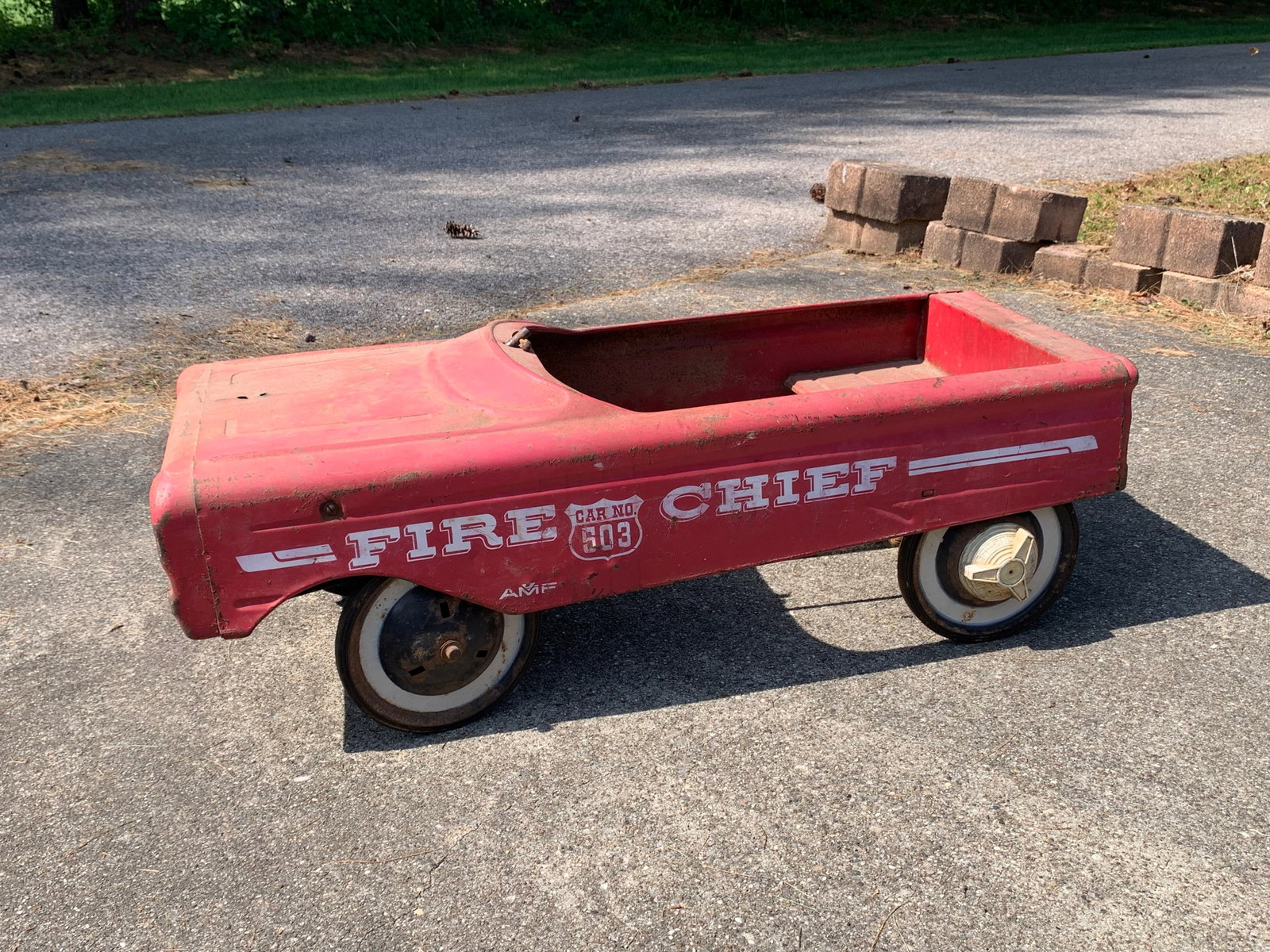 AMF Fire Chief Car No. 503 Pedal Car: AMF Fire Chief No. 503 pedal car manufactured by American Machine and Foundry, circa 1960s. The body is constructed from heavy-gauge pressed steel and features a red painted finish. White graphics on 