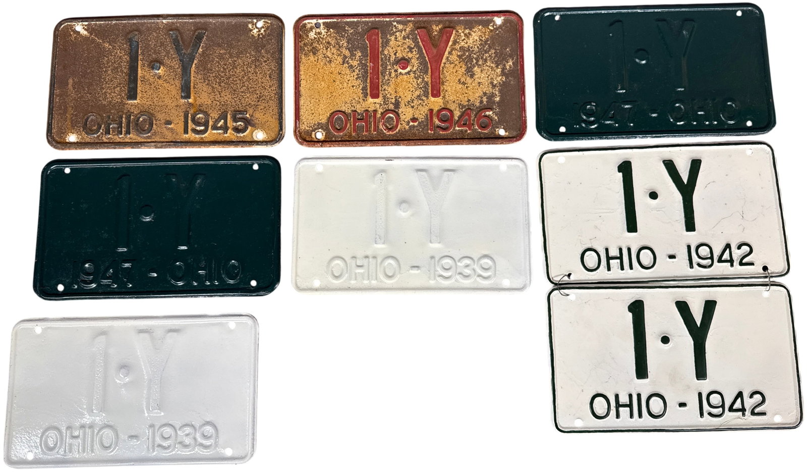 A collection of Vintage Ohio Motorcycle License Plates, 1939-1947: An assortment of embossed metal motorcycle license plates issued by the state of Ohio, dating from 1939 to 1947. Each plate in this collection bears the identical registration alphanumeric 1. Y. The l