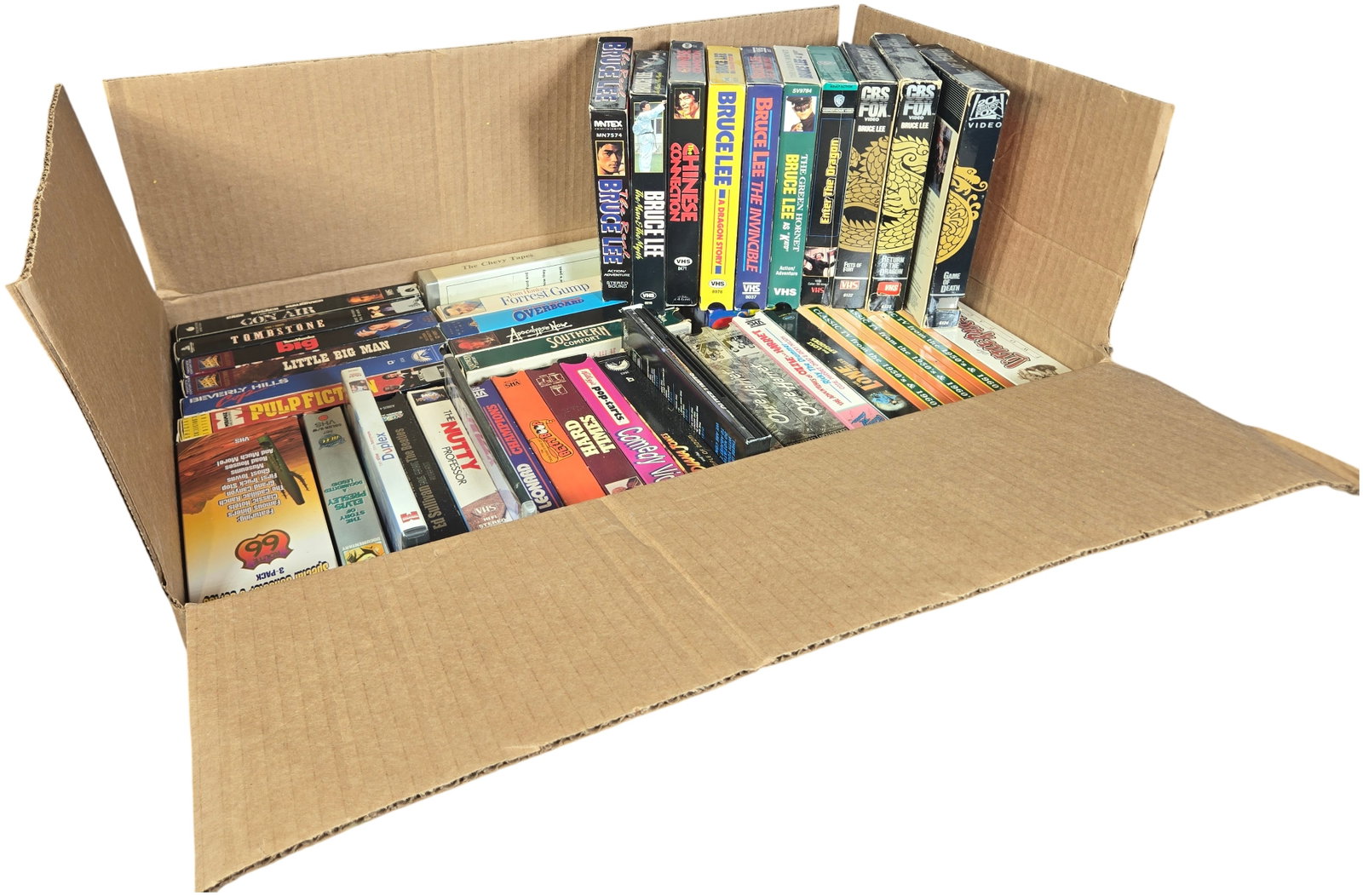 A collection of VHS Tapes and Select DVD Titles Featuring Martial Arts and Classic Hollywood Cinema: This large collection comprises a collection of media titles, primarily consisting of VHS tapes in original cardboard slipcases and plastic cases, alongside select DVD titles. The lot is highlighted b