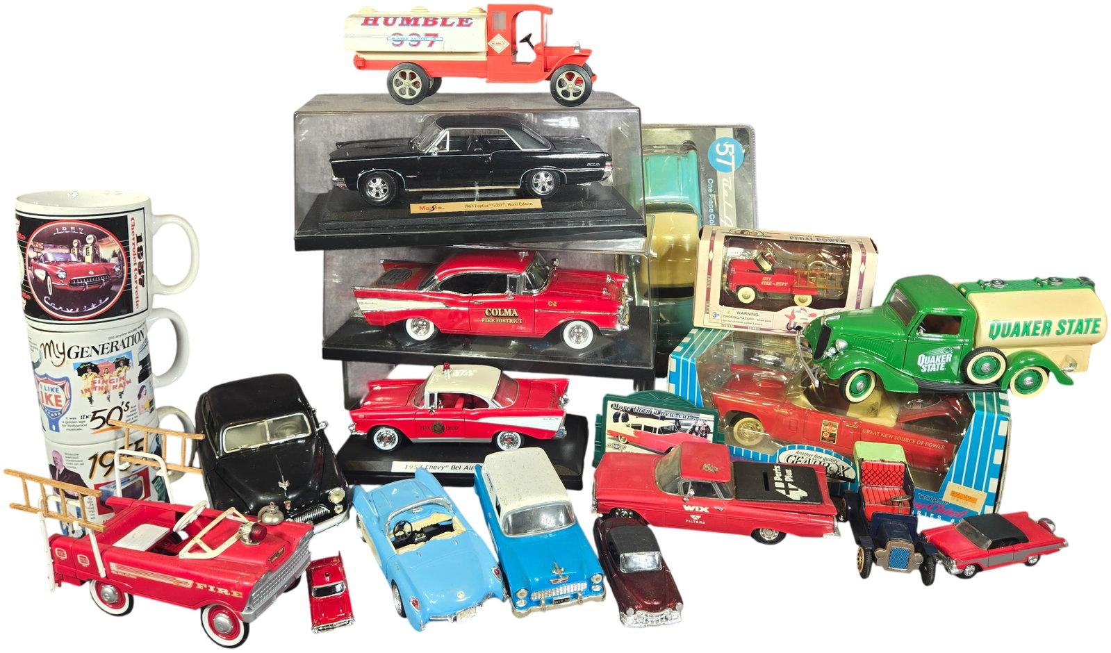 A collection of Vintage Die-Cast and Plastic Automotive Collectibles and Themed Mugs: This collection features an assortment of scale model vehicles, promotional items, and automotive-themed ceramic mugs. The lot includes large-scale die-cast models such as a Maisto 1965 Pontiac GTO Hu