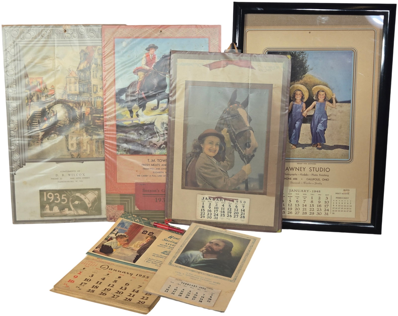 A group of Vintage American Advertising Wall and Desk Calendars, 1933-1958: This is an assortment of vintage American commercial advertising calendars featuring various graphic styles and regional business promotions from the mid-20th century. The collection includes: an. A 1
