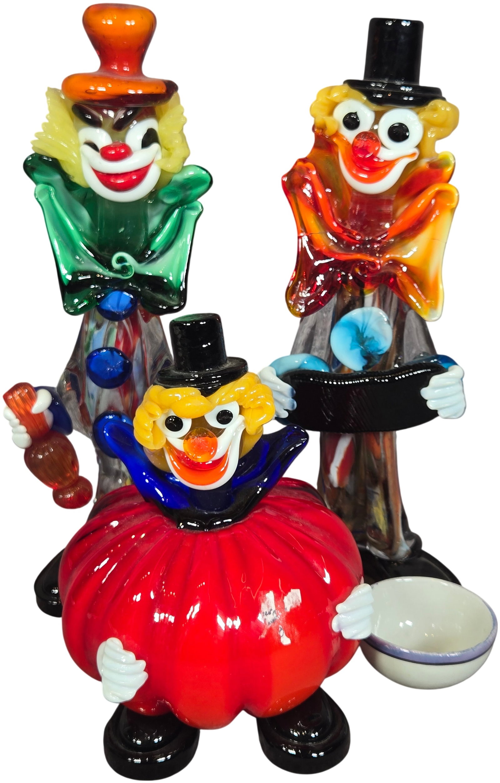 An Assortment of Vintage Art Glass Clown Figurines and a Ceramic Teacup: This lot features three vintage art glass clown figurines in the style of Murano along with a miniature ceramic teacup. Each glass piece is crafted from hand-blown and lampworked multi-colored glass. 