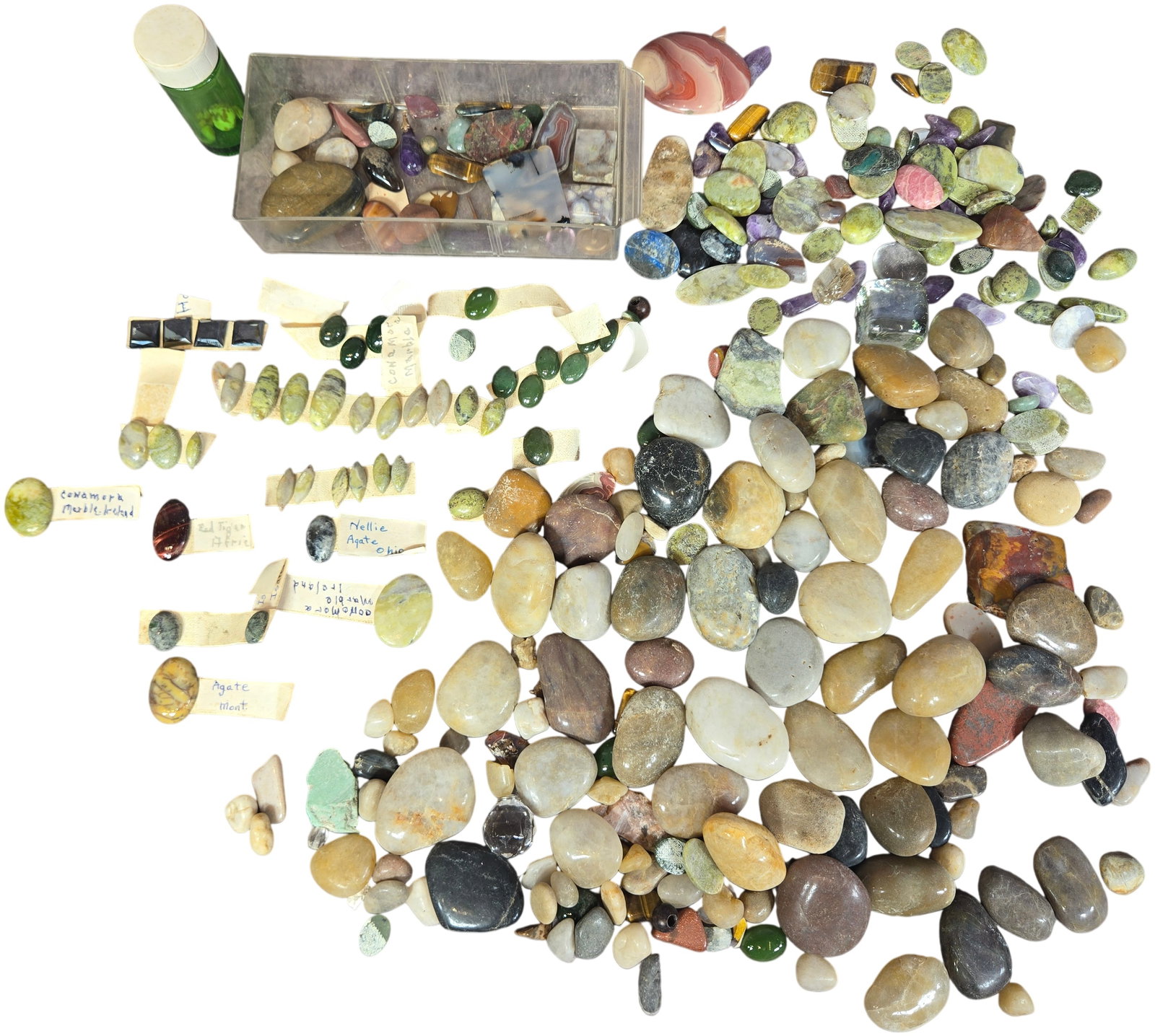 An Assortment of Semi-Precious Gemstones, Polished Cabochons, and Mineral Specimens: This lot comprises an assortment of semi-precious gemstones and mineral specimens in various states of lapidary preparation. The collection includes tumbled stones, shaped cabochons, small polished sl