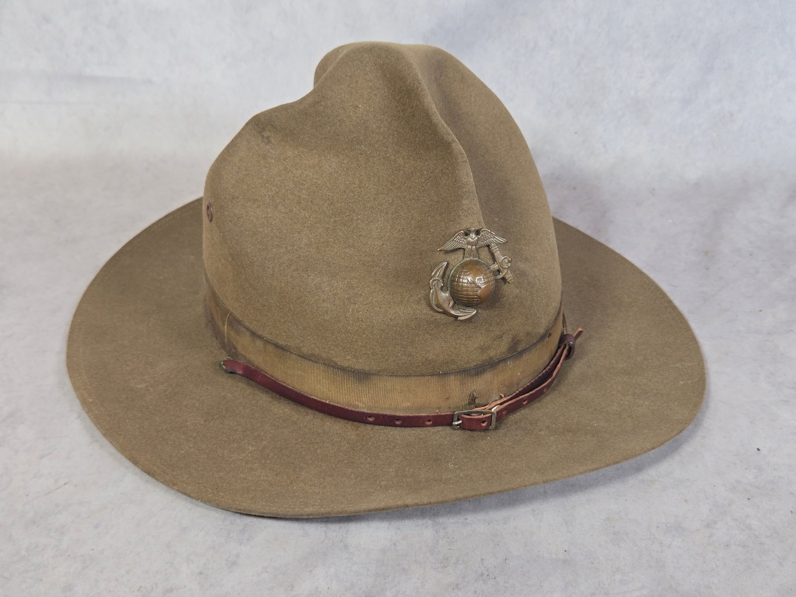 U.S. Marine Corps World War I - Interwar Era Officer's M-1912 Campaign Hat by Stetson: A United States Marine Corps (USMC) M-1912 campaign hat, also known as a Montana Peak hat, dating from the World War I to the Interwar period. The hat is constructed from olive drab wool felt and feat