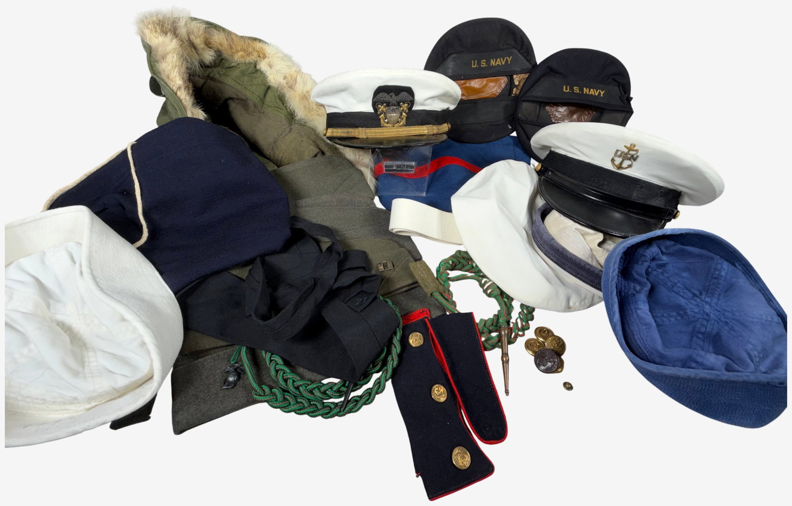 A Collection of United States Navy and Marine Corps Uniform Items and Headgear: An assortment of mid-20th century United States military uniform items and accessories primarily from the World War II and Korean War eras. The lot features a United States Navy officer white combinat