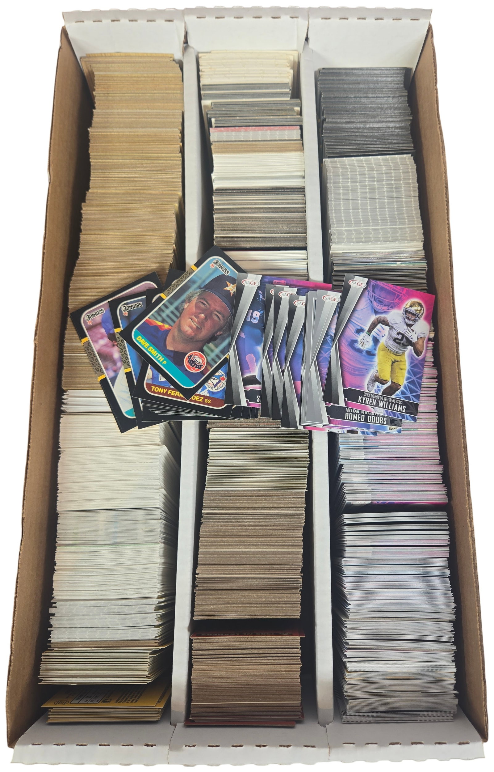 Large Collection of Baseball and Football Trading Cards in Four-Row Storage Box: An assortment of sports trading cards consisting of several thousand items housed in a four-row cardboard storage box. The collection features a mixture of baseball and football cards across several e