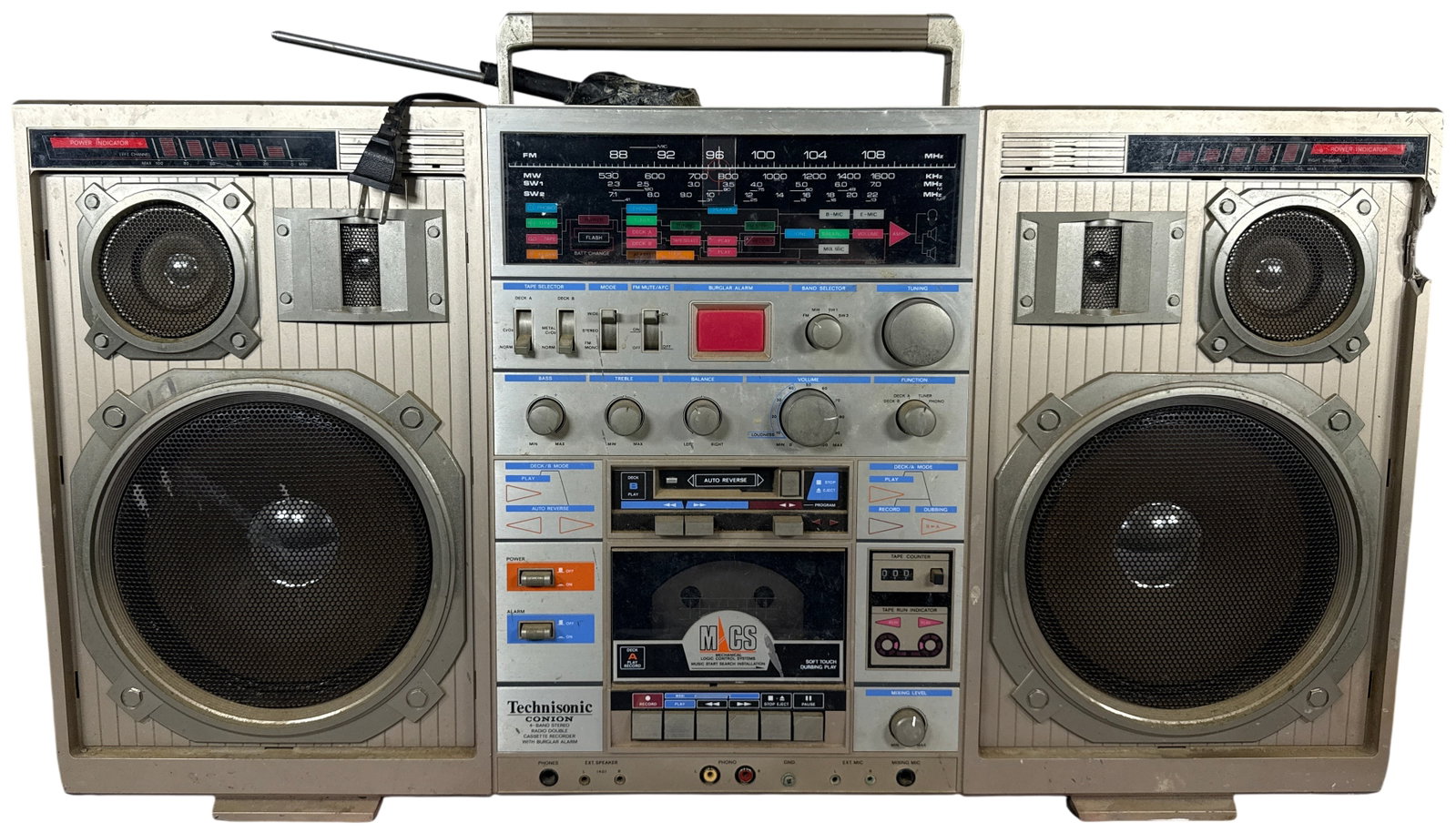 Technisonic Conion TC-999 4-Band Stereo Radio and Double Cassette Recorder: This Technisonic Conion model TC-999 is a vintage portable 4-band stereo radio and double cassette recorder, a device commonly referred to as a boombox. The unit is constructed with a molded plastic