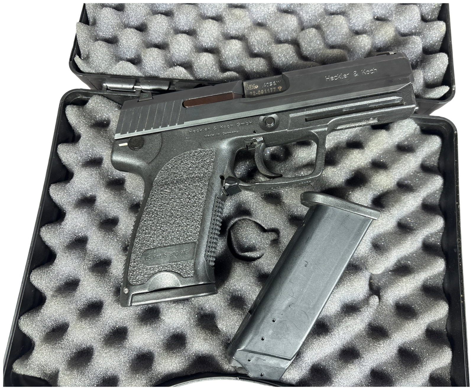 ** Heckler and Koch USP Semi-Automatic Pistol .40 S&W with 4 Inch Barrel 2004: This semi-automatic pistol is a Heckler and Koch USP chambered in .40 S&W, featuring a 4 inch barrel and a duty-oriented configuration. The firearm is constructed with a matte black finished steel sli