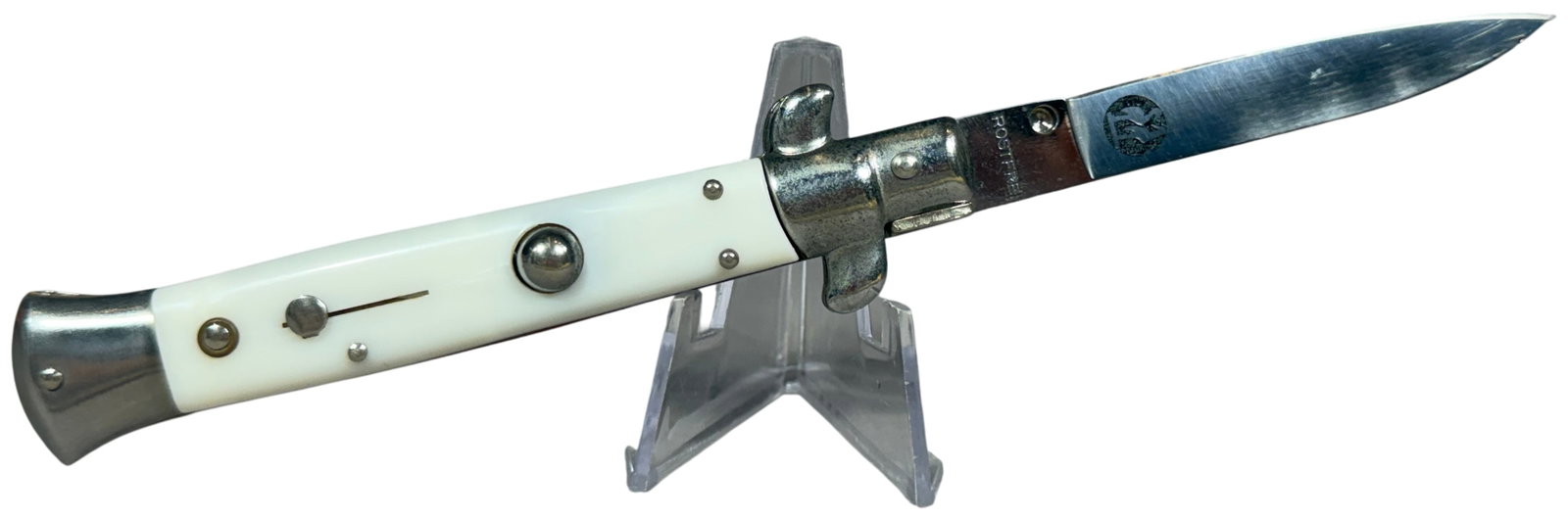 Kissing Crane Italian Style Stiletto Automatic Knife with White Pearloid Handle: A Kissing Crane Italian-style automatic stiletto folding knife. The stainless steel blade is a spear-point pattern and features the Kissing Crane circular double bird logo tang stamp above the word RO