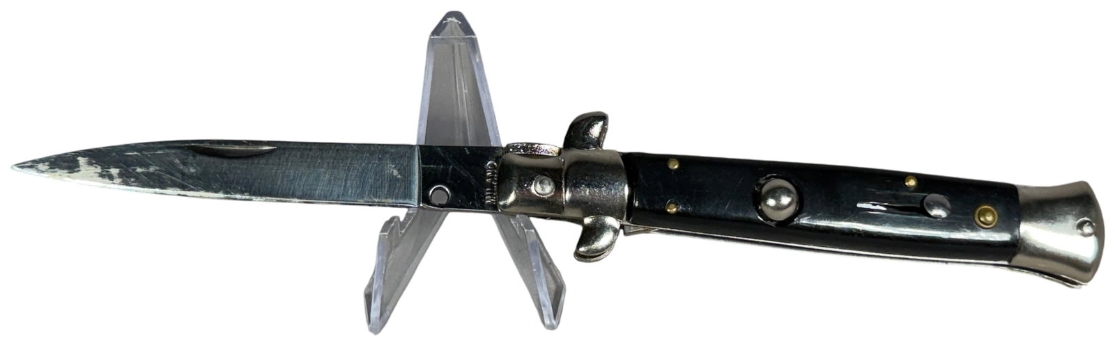 Italian Milano Stiletto Automatic Folding Pocket Knife: An Italian-style automatic stiletto folding pocket knife featuring a polished stainless steel spear-point blade. The blade tang is stamped with the marking MILANO. The handle is constructed with black