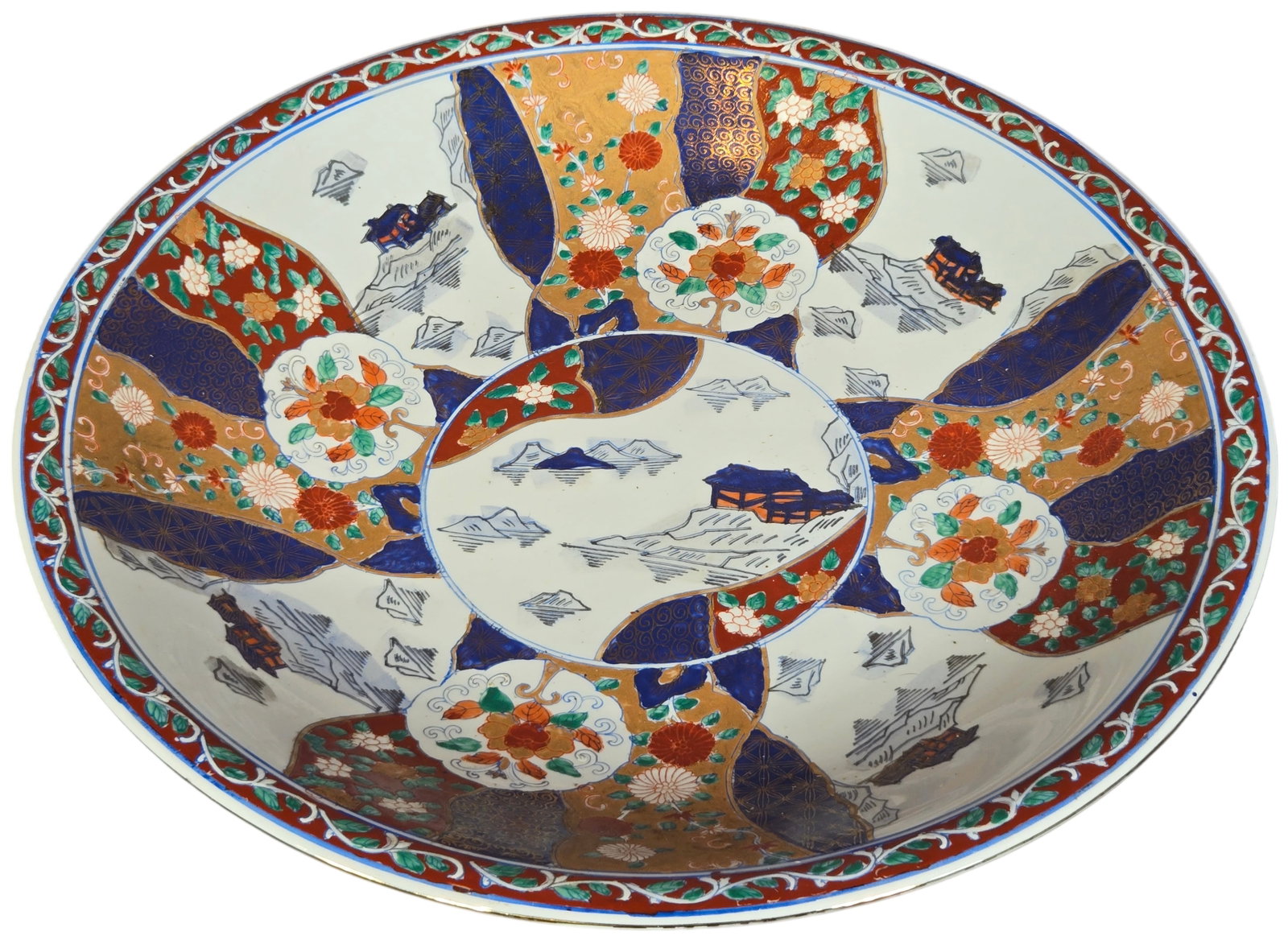 Large Macau Porcelain Imari Style Decorative Charger by Luen Shing: This large porcelain decorative charger features Imari style decoration utilizing underglaze blue with overglaze iron-red and green enamels and extensive gilding. The interior composition centers on a